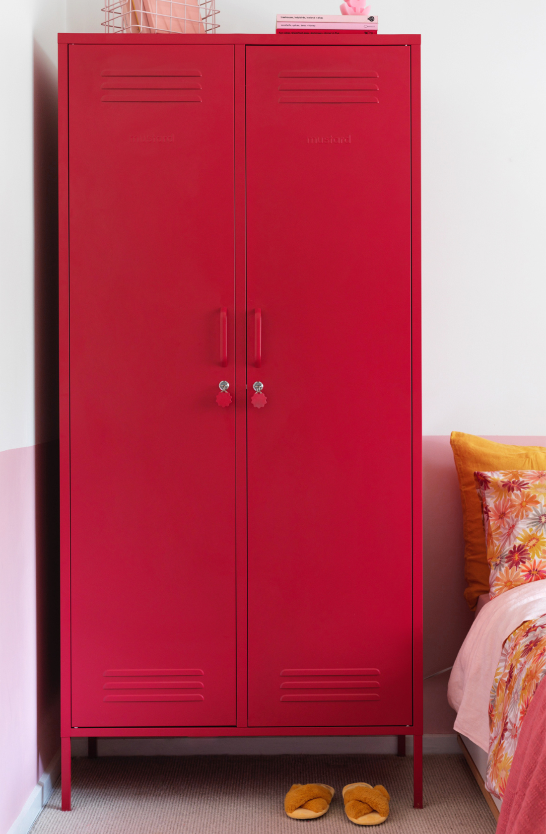 The twinny locker in poppy next to a bed.