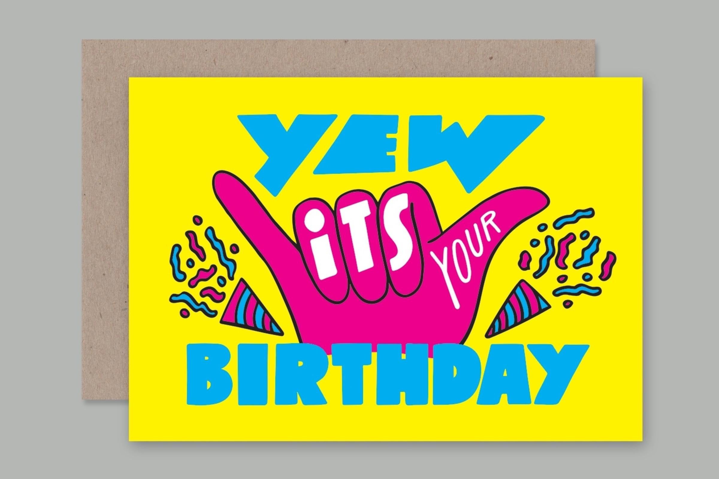 Check out the bright yellow Greeting Card "Yew It's Your Birthday" from AHD PAPER CO. It features colorful text in blue, pink, and white saying "YEW ITS YOUR BIRTHDAY," with a large pink hand making a 'rock on' gesture at the center. The card is adorned with festive decorations like confetti and party hats. Plus, it's printed using vegetable inks on recycled paper!