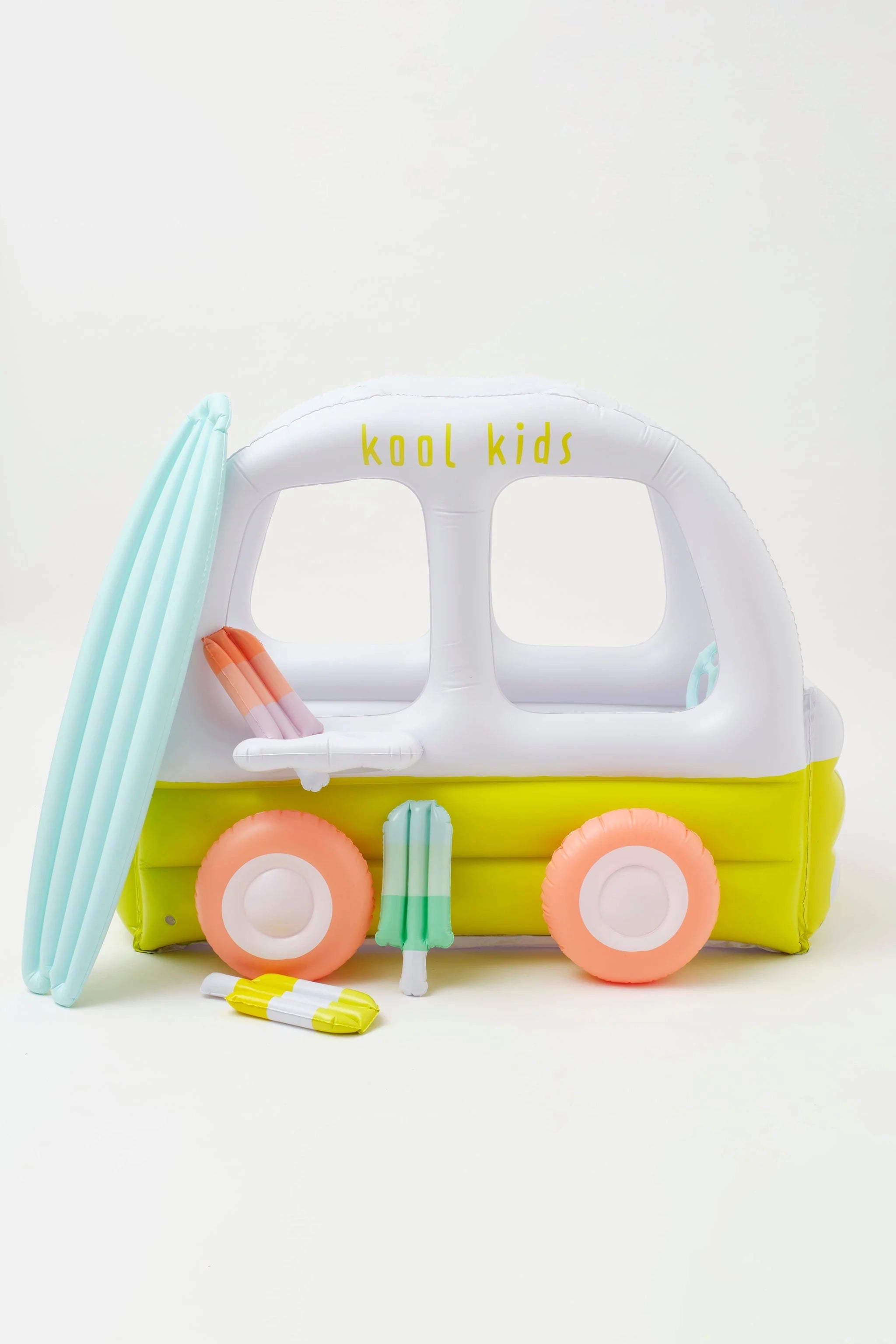 The Inflatable Cubby Ice Cream Van by SUNNYLIFE is crafted for kids and designed to look like an ice cream van, featuring a vibrant surfboard on the side. Primarily white and lime green with orange wheels, this durable PVC toy also includes a repair patch. The roof is adorned with the text "kool kids." Additionally, the set comes with three non-toxic, Phthalate-free toy ice creams in pastel colors.