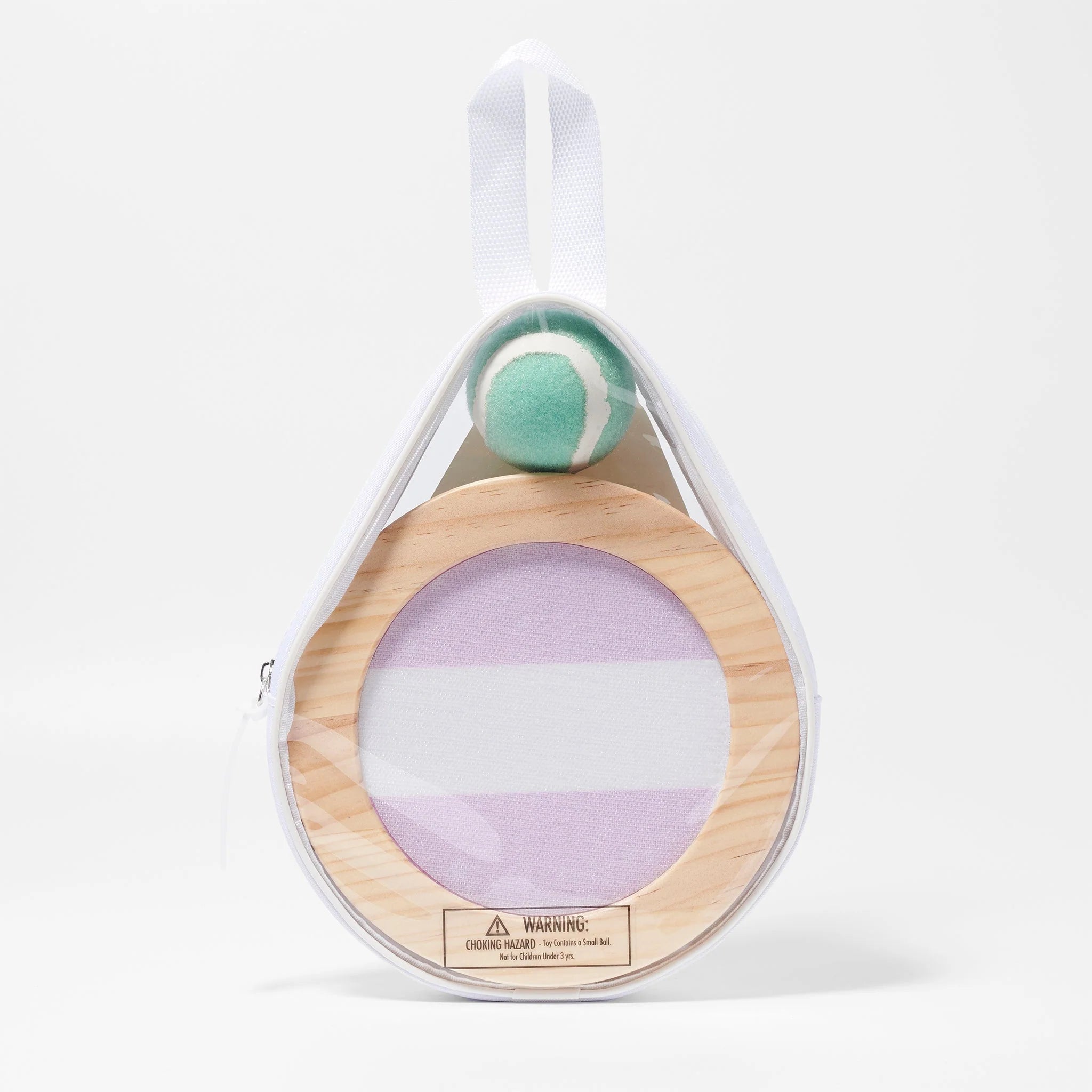 The SUNNYLIFE Catch Ball Set comes in a reusable carry bag featuring a white top handle. Inside, you'll find a wooden ring with a stretched fabric mesh resembling a small tennis racket and an accompanying green and white ball. The bottom of the wooden ring displays a warning label.