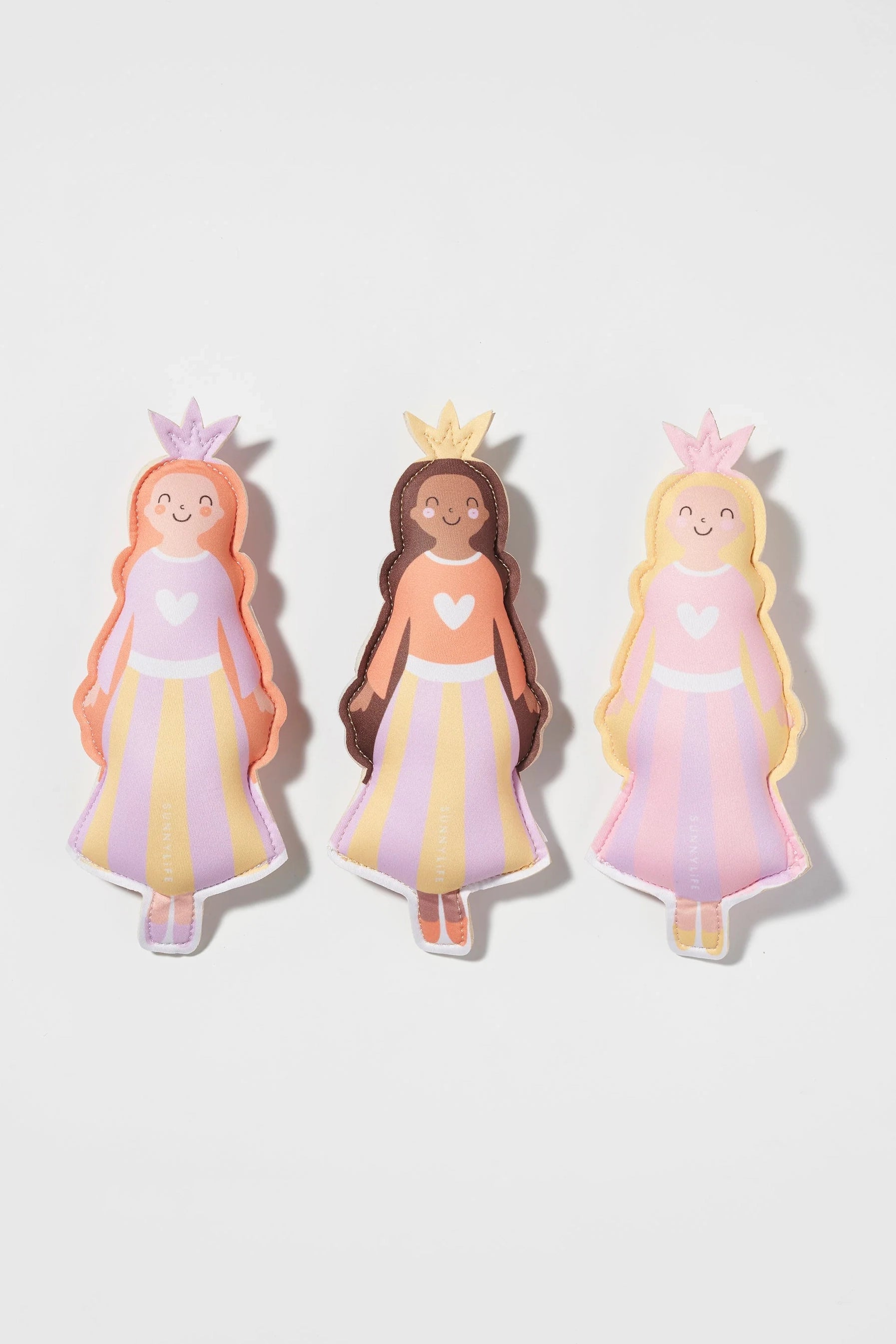 A set of 3 Princess Swan Dive Buddies from SUNNYLIFE, featuring colorful and smiling princess dolls with crowns and heart-shaped details on their pastel-shaded, striped dresses. Made from durable neoprene material, each princess has a different hair color: pink, brown, and blonde. These charming dolls are arranged in a row on a white background.