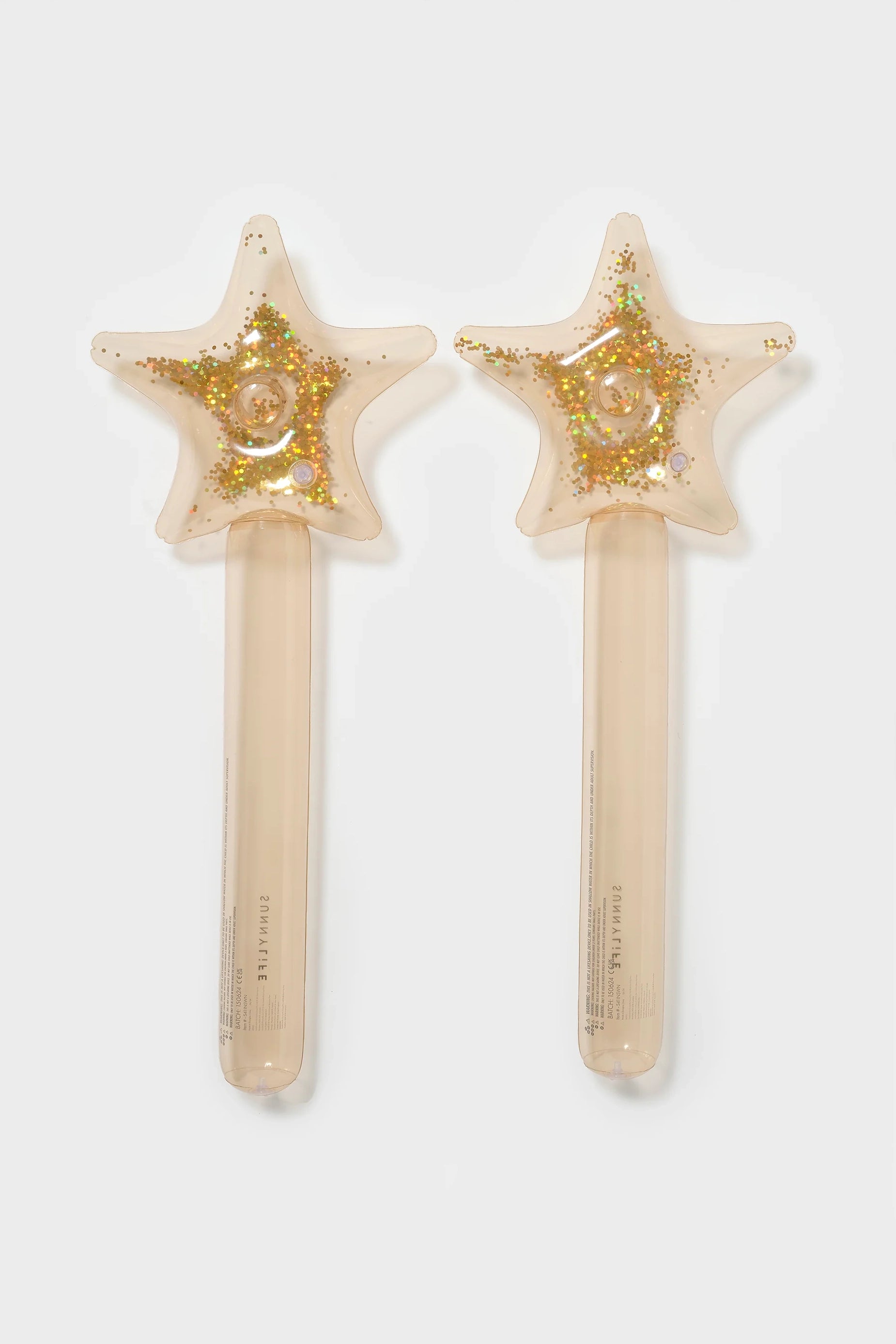 The Inflatable Star Wands (Set of 2) by SUNNYLIFE are translucent and star-shaped, featuring glitter and small spheres inside. Each wand has a beige handle adorned with colorful, confetti-like specks. Made from phthalate-free PVC, these wands appear to be ideal as children's toys or costume accessories.