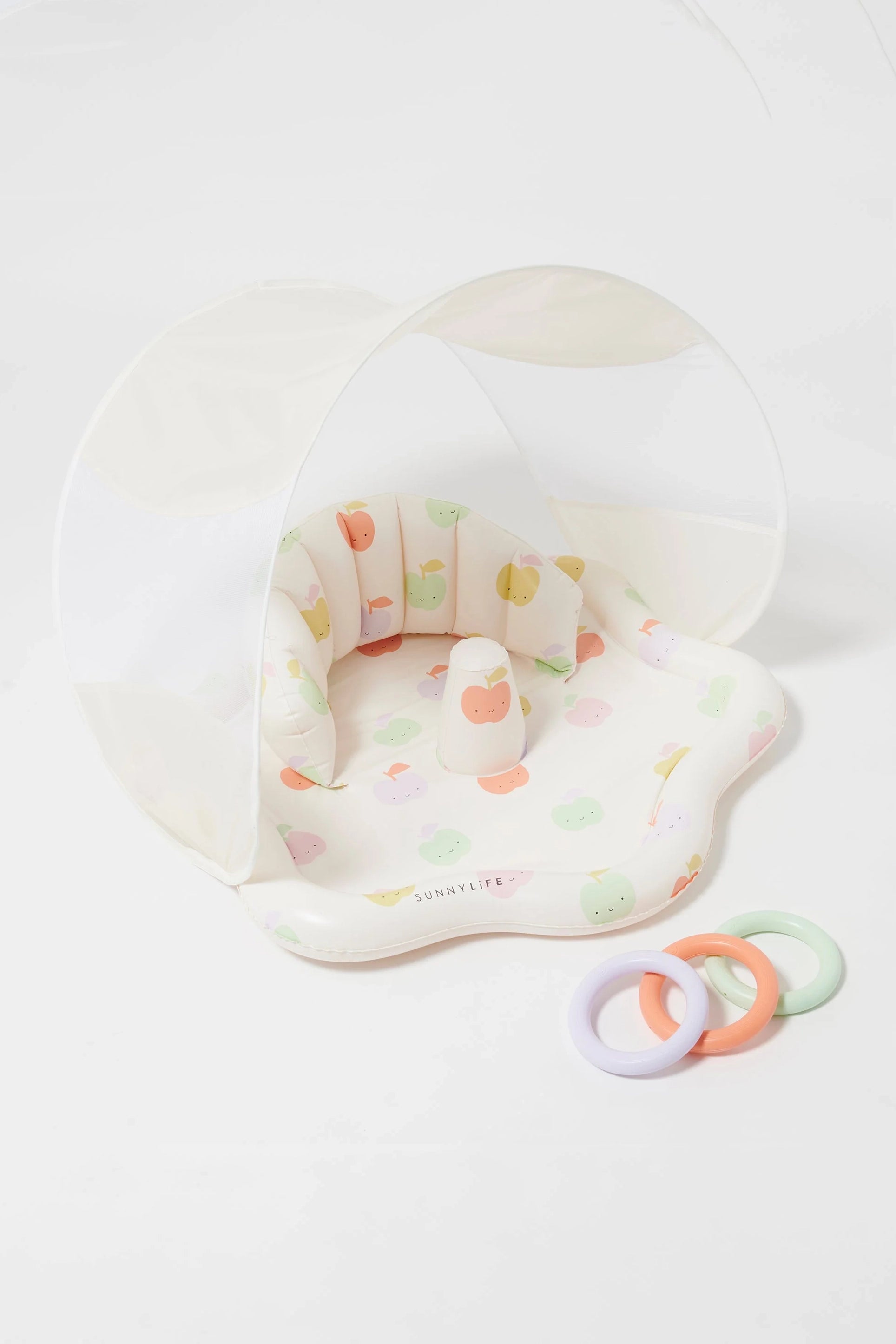 Explore the charming Baby Playmat with Shade by SUNNYLIFE, featuring an arching UPF40 canopy in soft, pastel colors adorned with an adorable fruit pattern. The comfortable cushion provides a cozy seating area, and it comes with three pastel-colored rings in lavender, pink, and green that enhance hand-eye coordination. The durable non-toxic PVC material proudly displays the brand name "SUNNYLIFE.