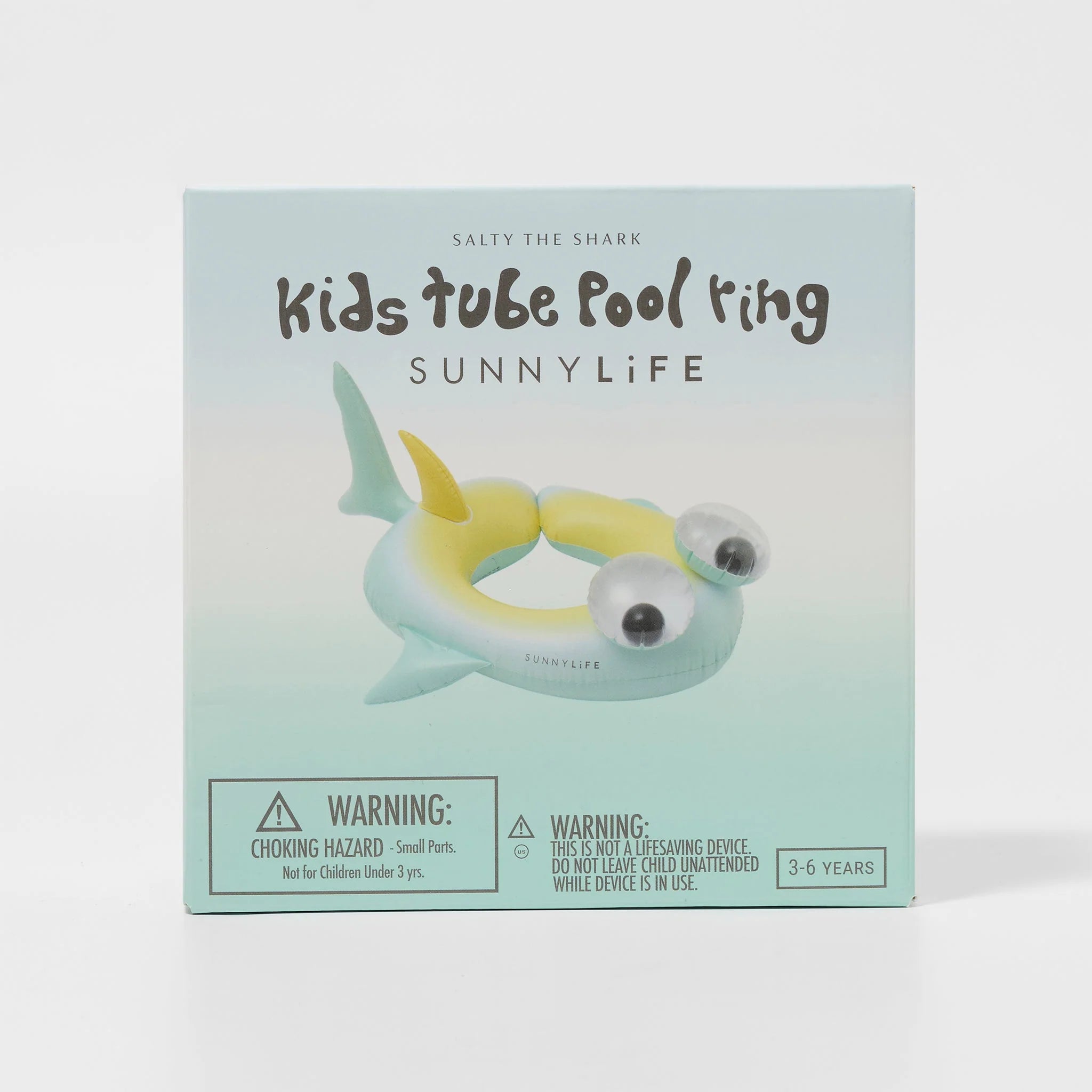 The image displays packaging for the "Kids Tube Pool Ring Salty the Shark" by SUNNYLIFE. The box features a shark-shaped pool ring made of durable PVC in pastel green and yellow, complete with safety warnings for children aged 3-6 years and a repair patch to ensure lasting fun.