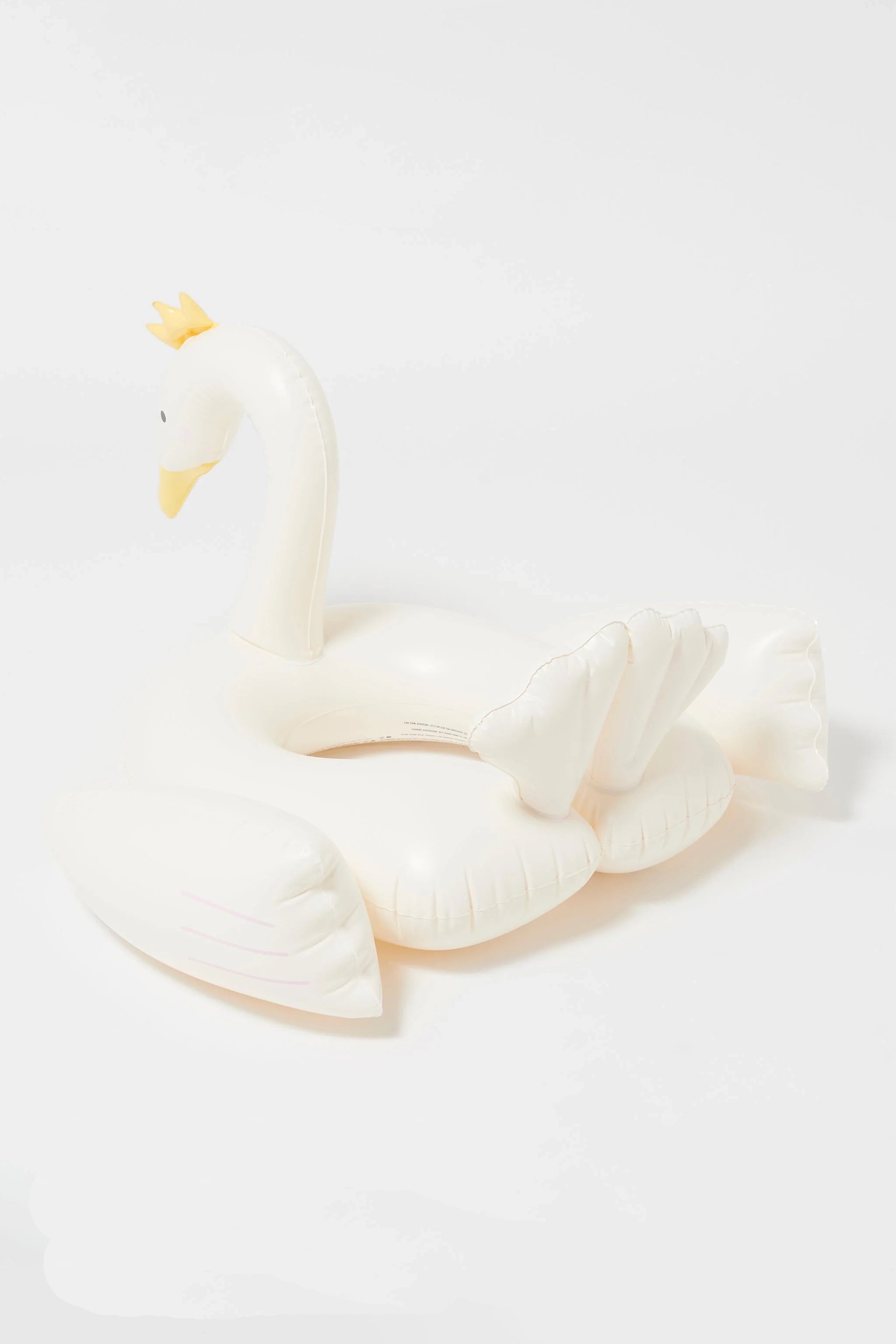 The SUNNYLIFE Kids Tube Pool Ring Princess Swan is an enchanting inflatable pool float designed in the shape of a white swan adorned with a gold crown on its head. Made from non-toxic, phthalate-free PVC, this durable float features detailed wings and a curved neck that add to its realistic and whimsical appearance, making it perfect for safe summer fun against a plain white background.