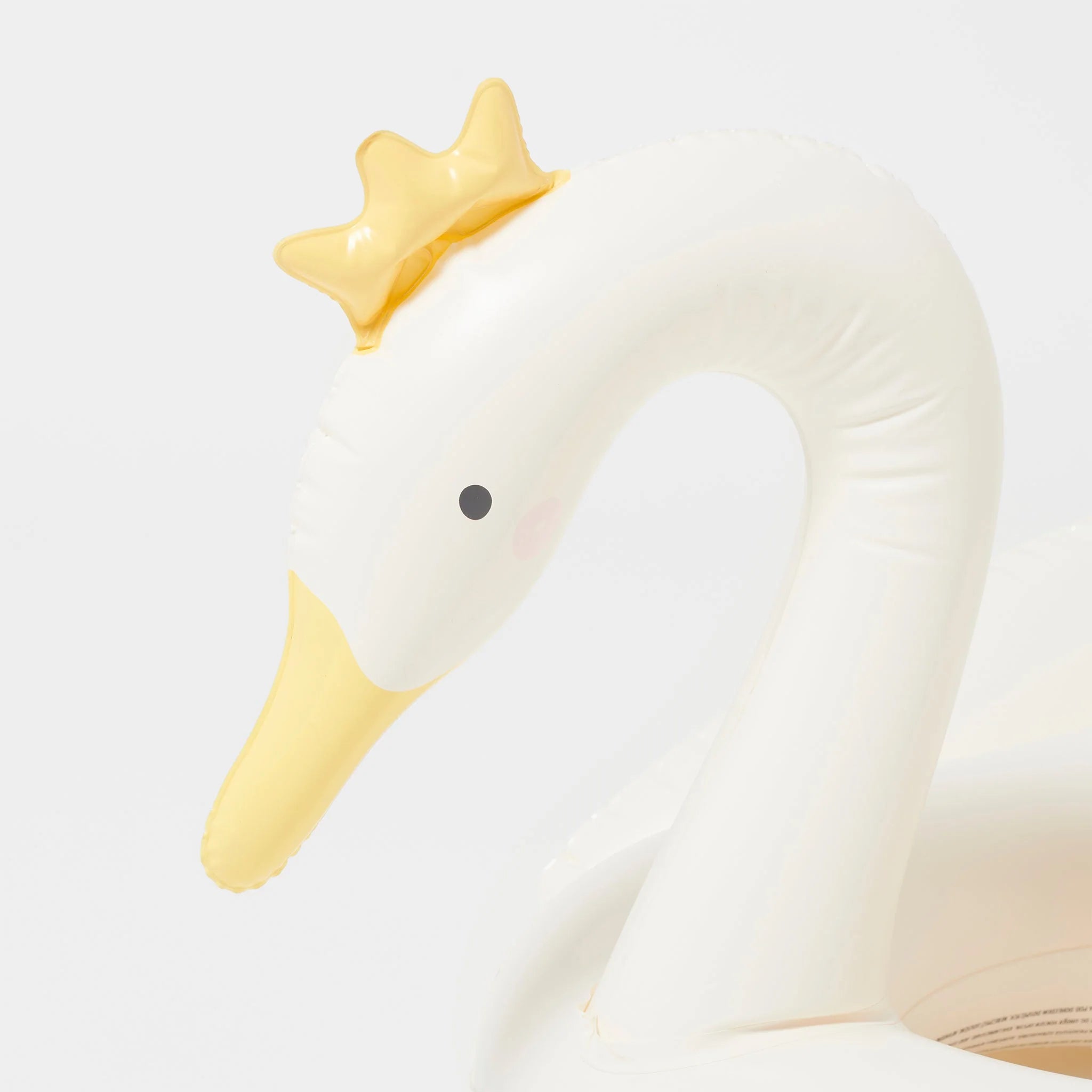 The Kids Tube Pool Ring Princess Swan by SUNNYLIFE is a durable, white inflatable swan with a yellow crown on its head. Made from non-toxic PVC, this swan features a yellow bill and a black eye set against its sleek, minimalist design on a plain white background.