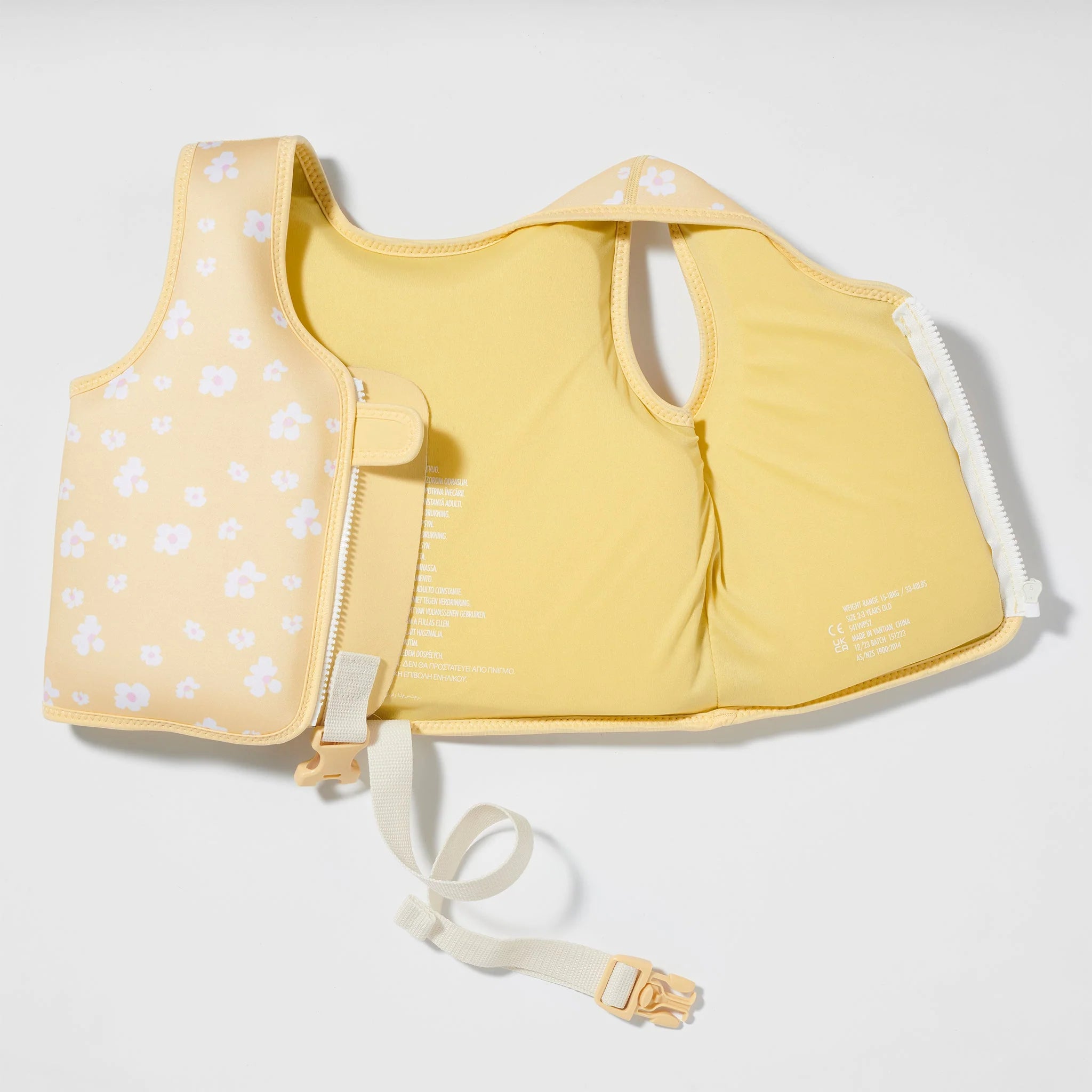 The SUNNYLIFE Kids Swim Vest Princess Swan/Buttercup is a yellow children's life jacket adorned with white flower patterns on one side. It includes an adjustable safety strap and a clip buckle at the bottom. Crafted from durable neoprene, this vest features a secure side closure designed to ensure safety during water activities while aiding in the development of swimming abilities.