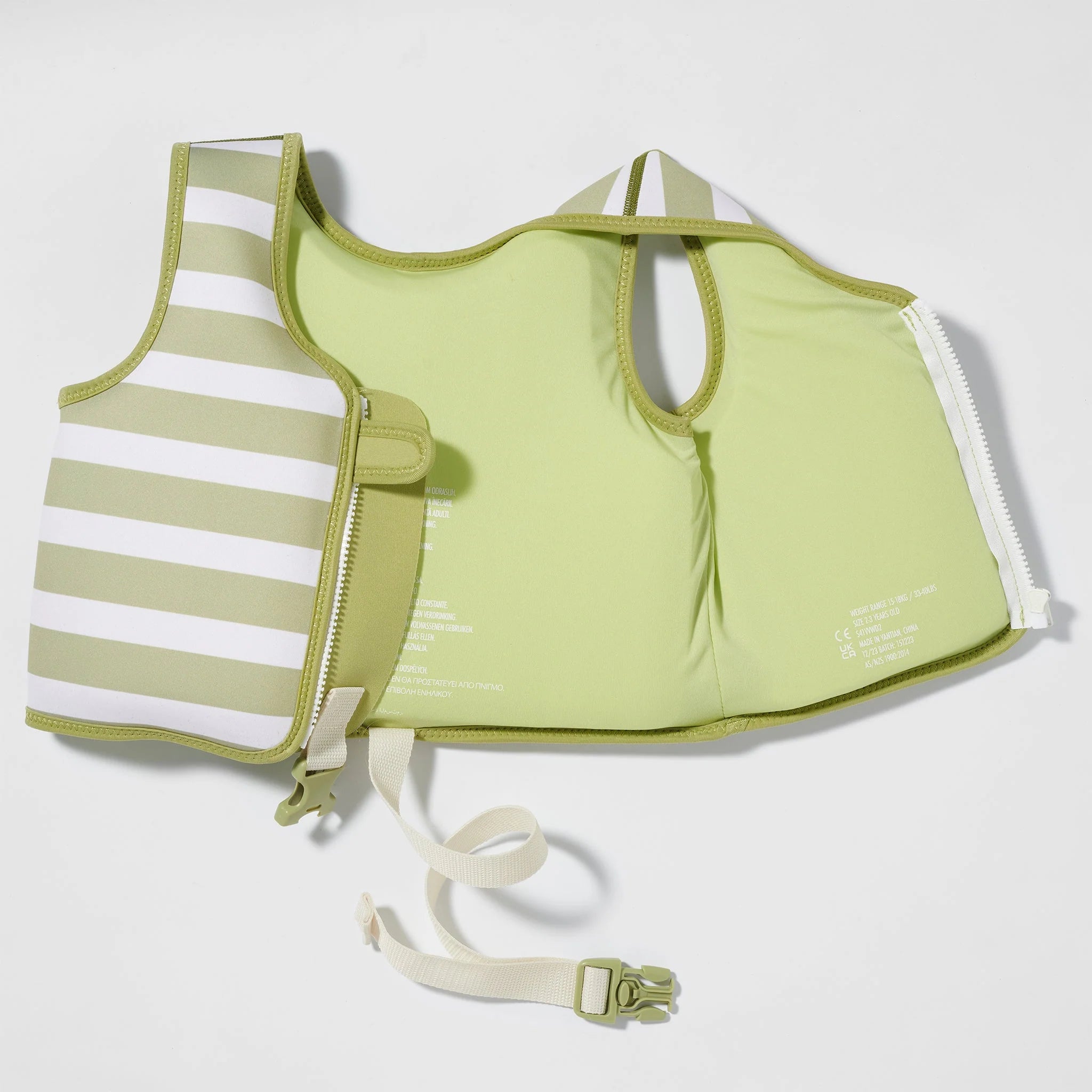 The SUNNYLIFE Kids Swim Vest Into the Wild/Khaki is a flotation vest designed for young children, made from durable neoprene and featuring a zip closure. This khaki and lime green striped vest includes adjustable straps and buckles to ensure a secure fit, an adjustable safety strap for added security, and text lining that provides important safety and usage information.