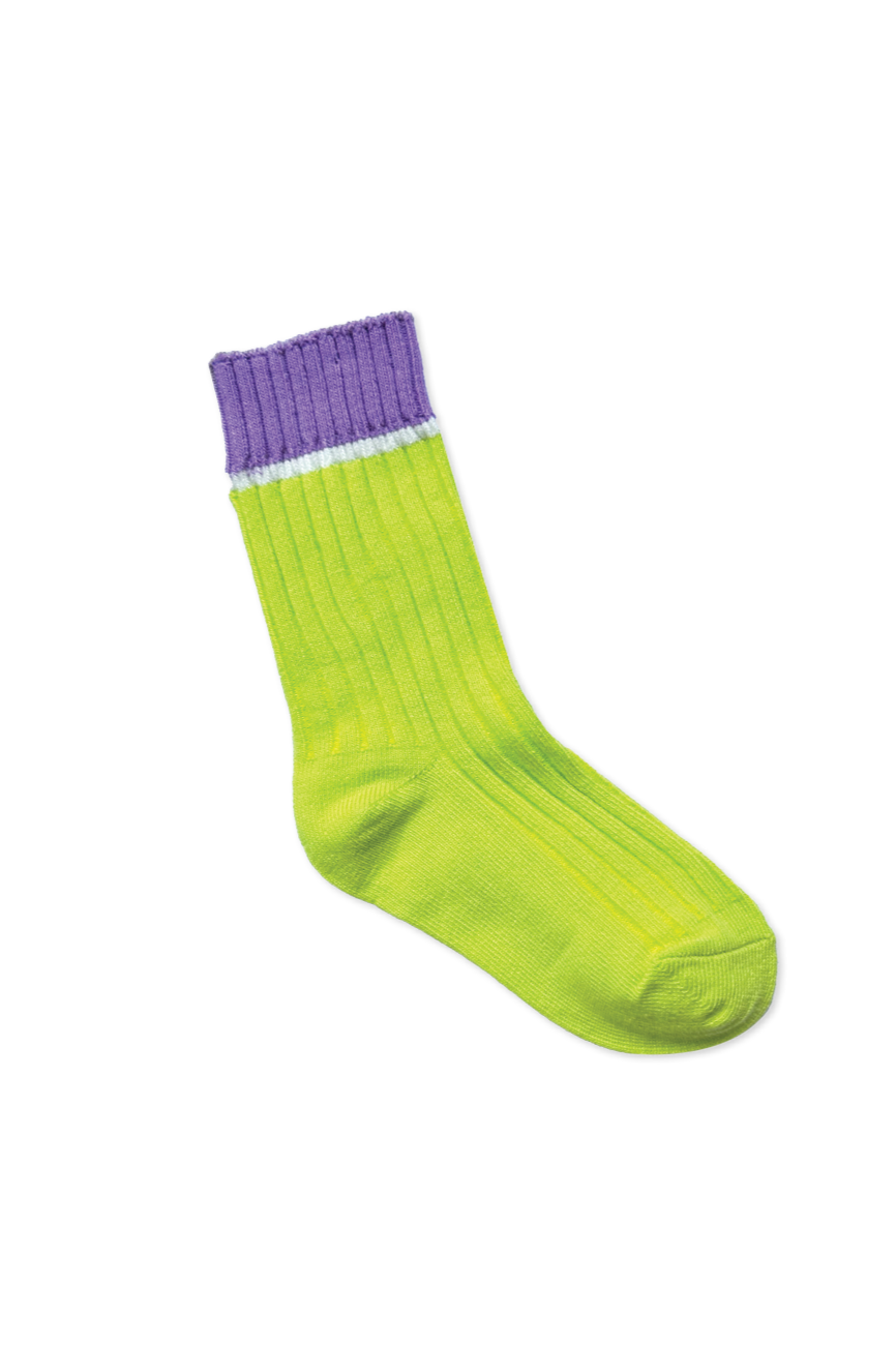 A lone "Fun Socks Citrus" sock by SONNY LABEL, featuring a green body with a purple cuff and a thin white stripe in between, stands isolated on a black background.