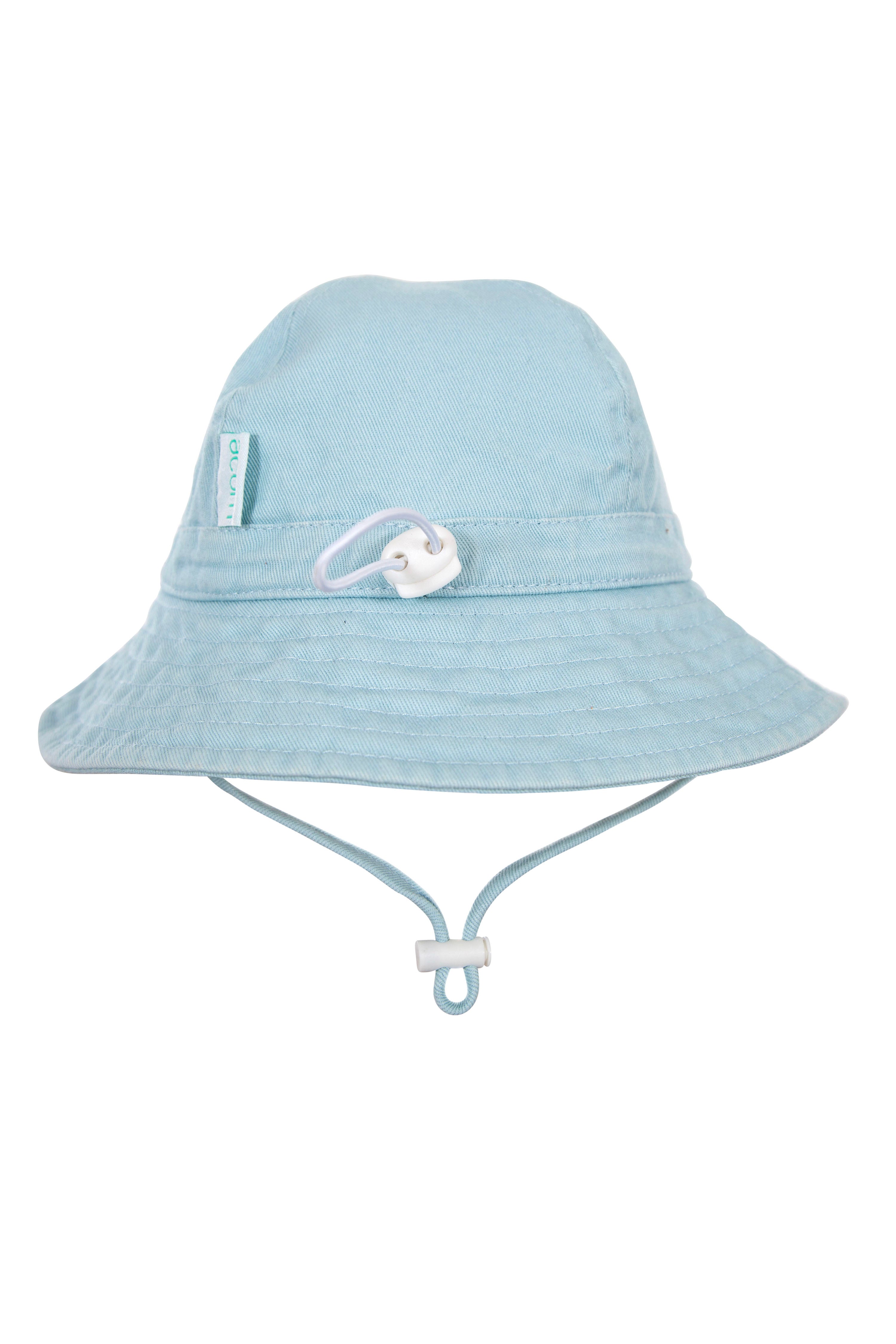 The ACORN KIDS Wide Brim Infant Hat Blue is a light blue hat made from cotton canvas, featuring UPF50+ sun protection. It includes an adjustable string with a toggle for securing the hat under the chin and has a small fabric tag on the side. The product background is plain white.