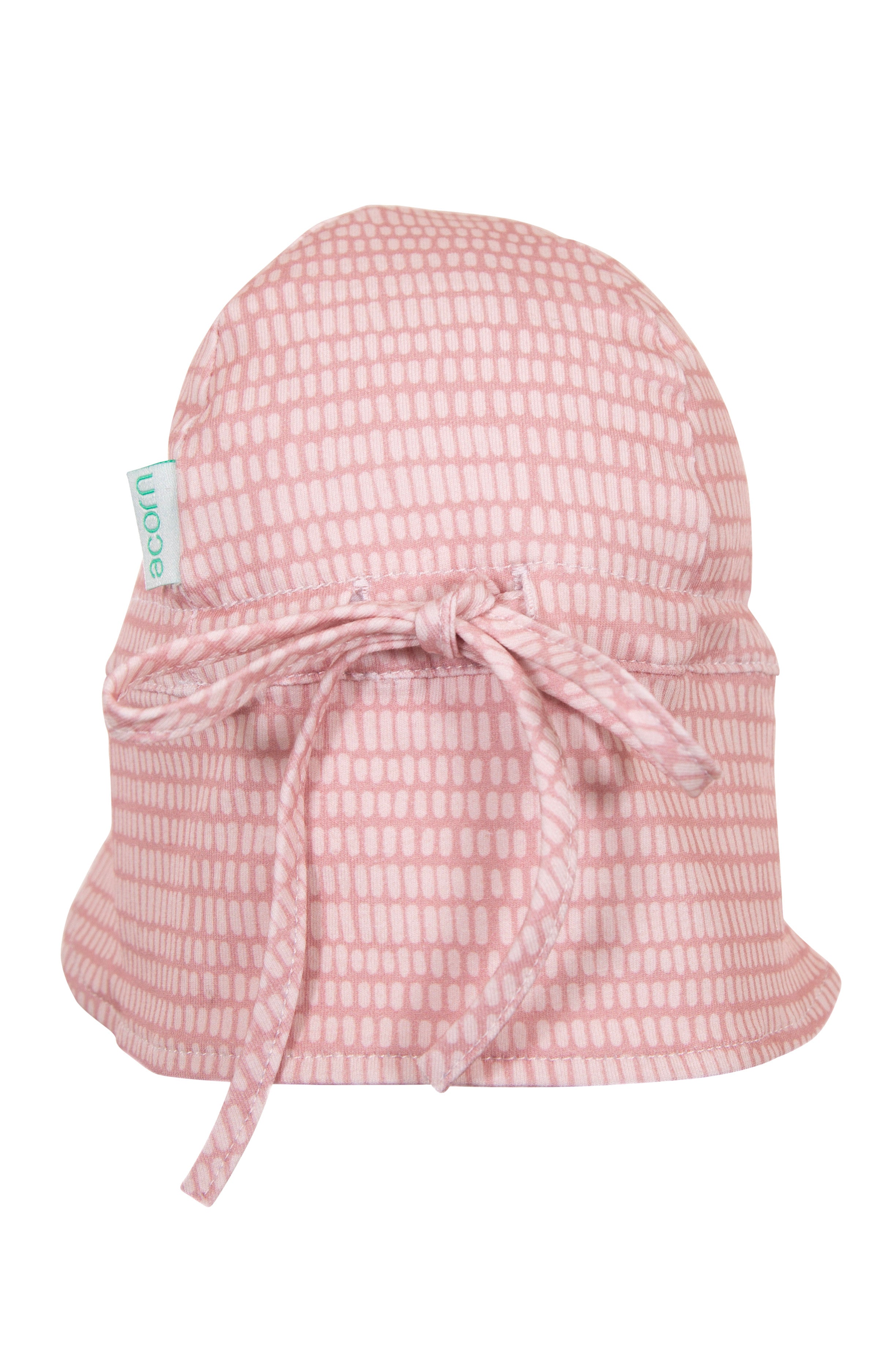 The Dashes Flap Hat Rose by ACORN KIDS is a pink baby bucket hat adorned with a rose-colored dashes print and grid pattern, made from cotton jersey fabric. It has a tied bow at the back and offers UPF50+ sun protection.