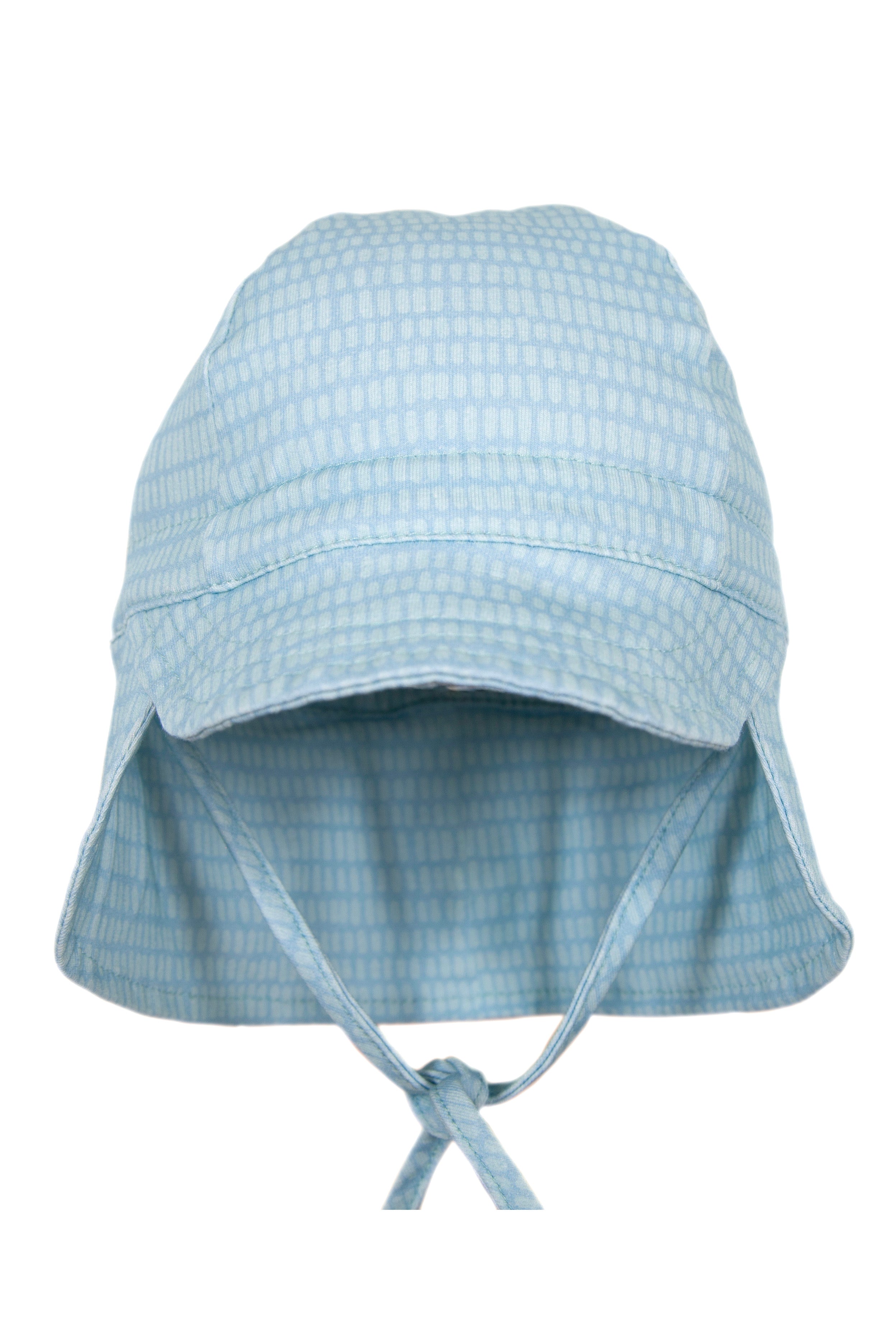 The Dashes Flap Hat Teal by ACORN KIDS is a light blue bucket hat featuring UPF50+ protection and chin-tie strings. Made from 100% cotton jersey, it boasts a subtle checkered pattern and is showcased against a plain white background.