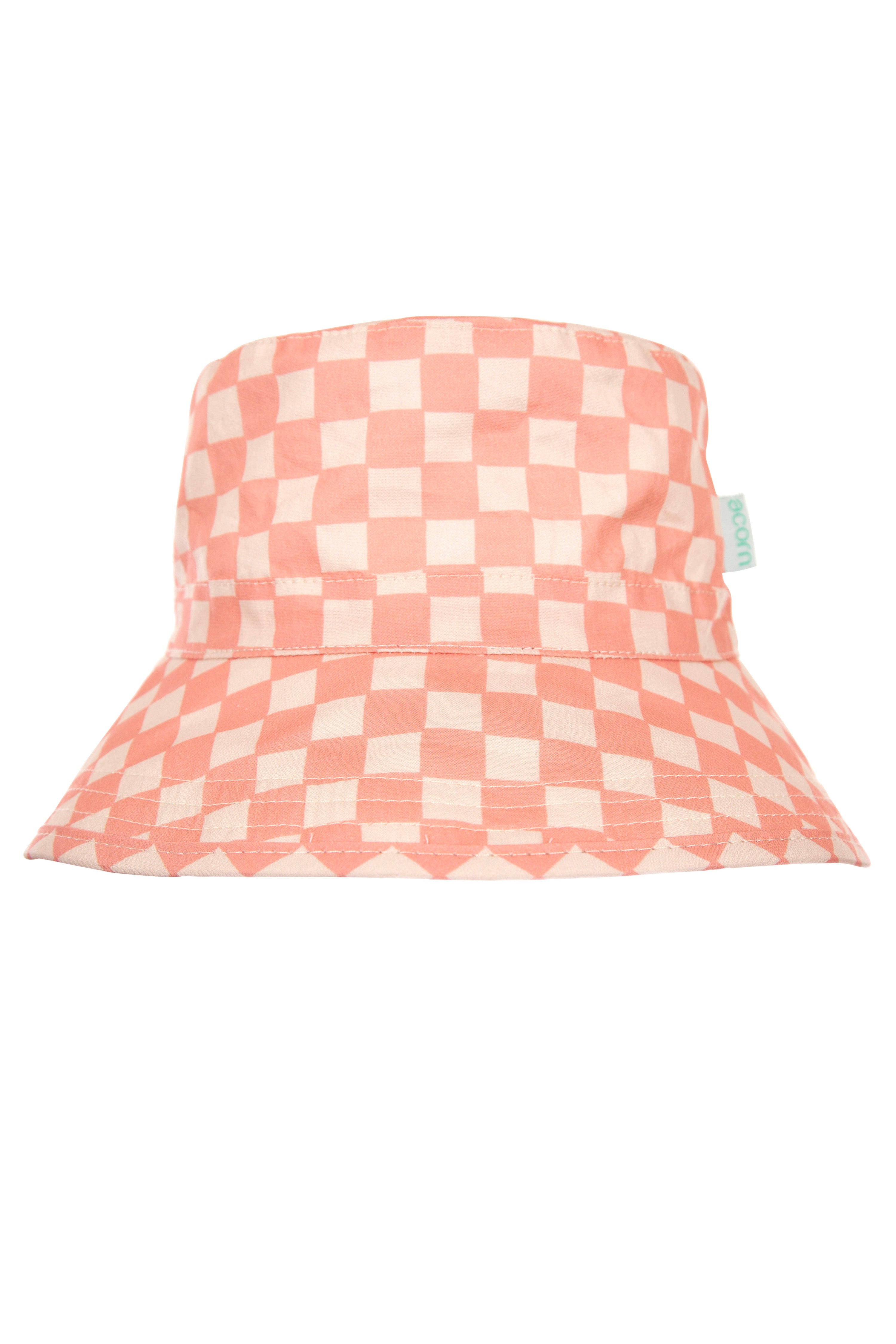 The Pink Checks Broad Brim Bucket Hat by ACORN KIDS combines a pink and white checkered cotton pattern with evenly spaced squares for a playful, stylish appearance. It features a small green tag on the side and offers excellent sun protection with its wide brim and round, soft top.