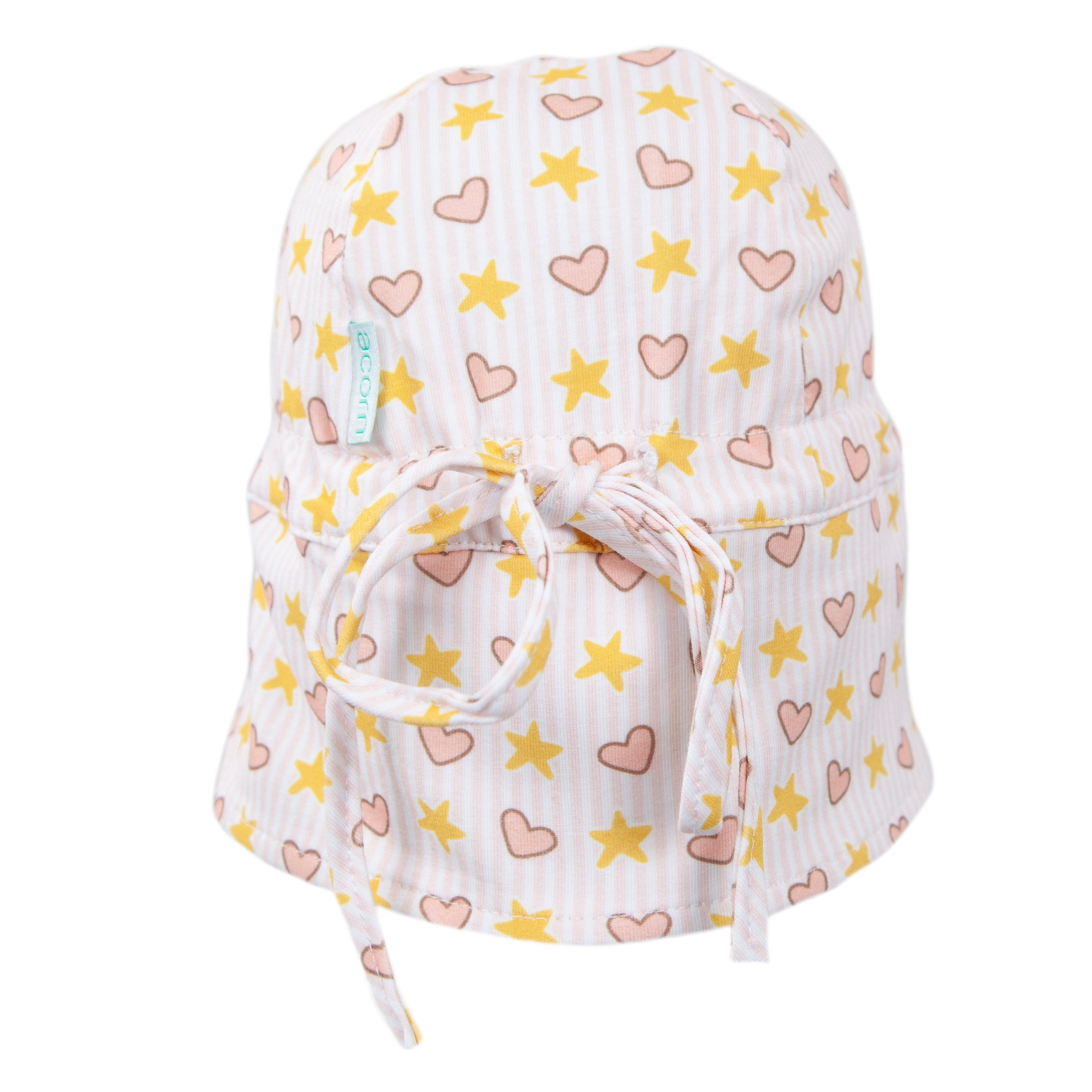 The Acorn Kids - Love and Stars Flap Hat by ACORN KIDS is a soft cotton jersey baby hat with yellow stars, pink hearts, a back bow, blue-and-white side label, and UPF50+ for extra outdoor comfort.