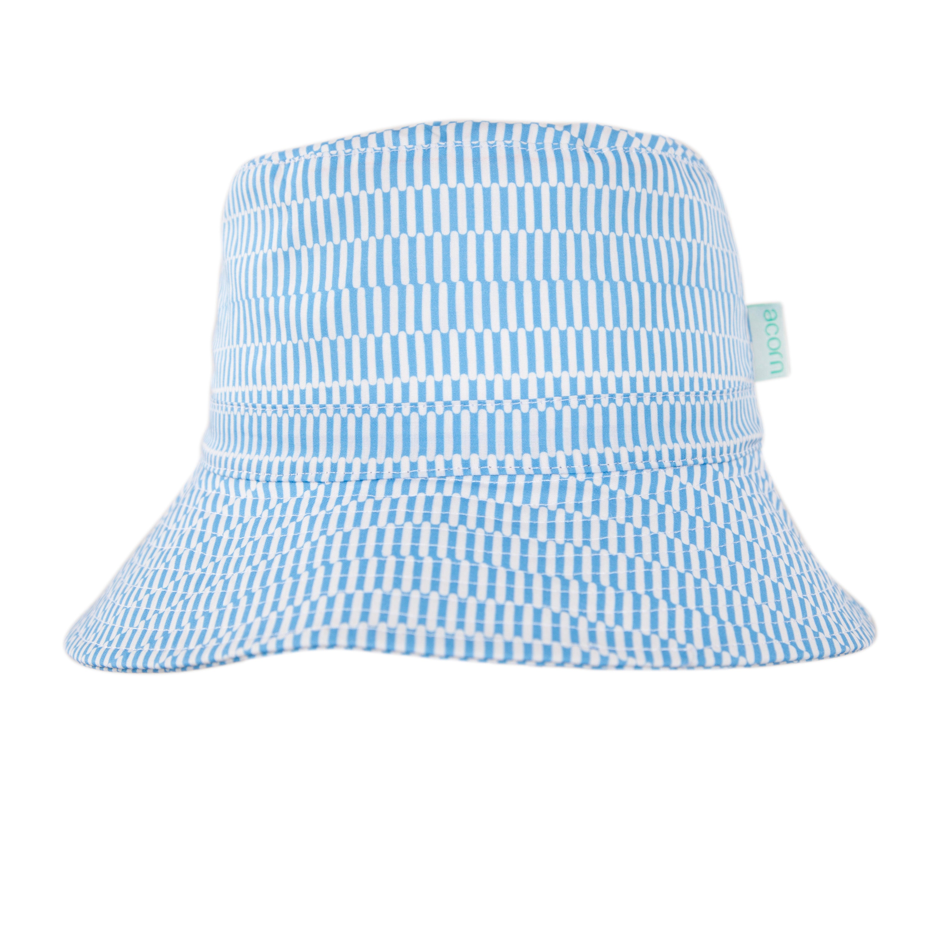 The ACORN KIDS Mykonos Wide Brim Bucket Hat is blue and white with a geometric stripe, made from 100% cotton, features UPF50+ sun protection, and has a small light blue side tag.