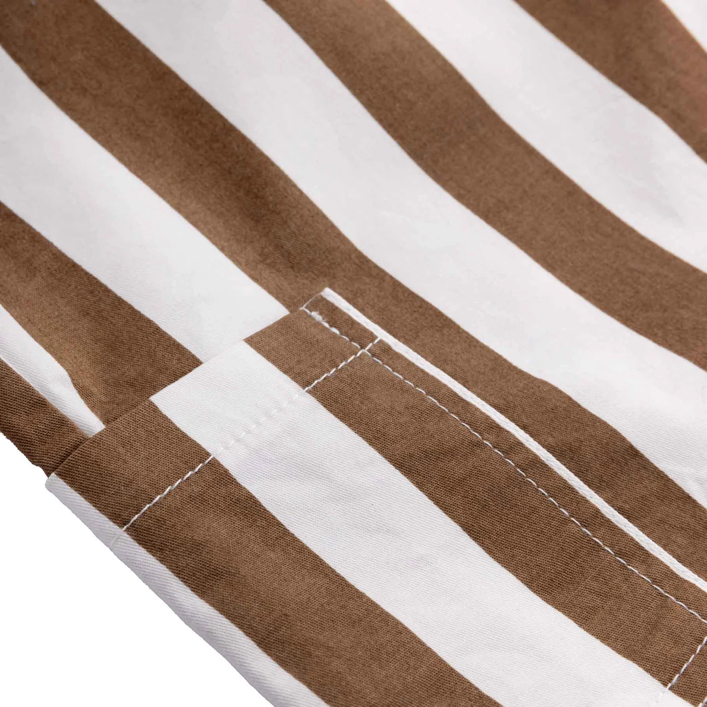 Close-up of the Tei Shorts Brown/White Stripe by LITTLE THE LABEL, highlighting brown and white vertical stripes with visible stitching along a seam, similar to classic boys' cotton poplin shorts.