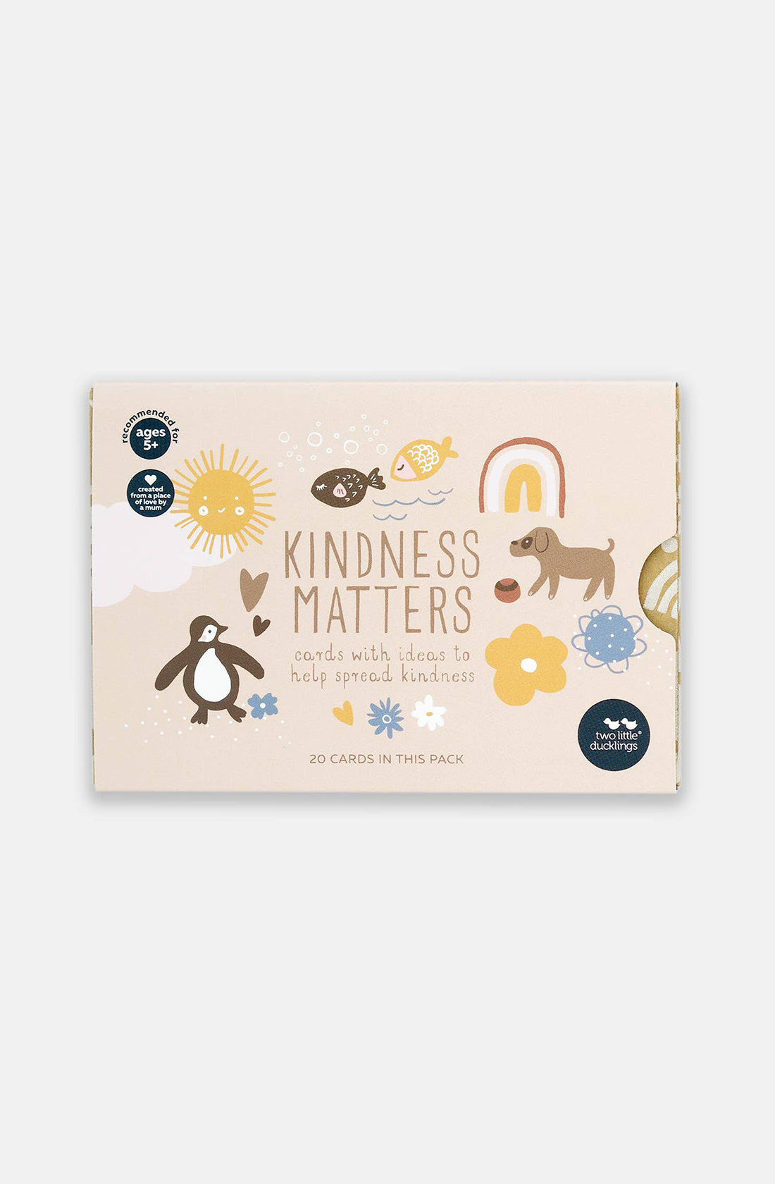 A beige box from TWO LITTLE DUCKLINGS is adorned with illustrations of a sun, rainbow, penguin, dog, fish, and flowers. Labeled "Kindness Matters," the box contains "cards with ideas to help spread kindness." These environmentally friendly cards feature 20 acts of kindness suggestions and are suitable for children aged 4 and up.