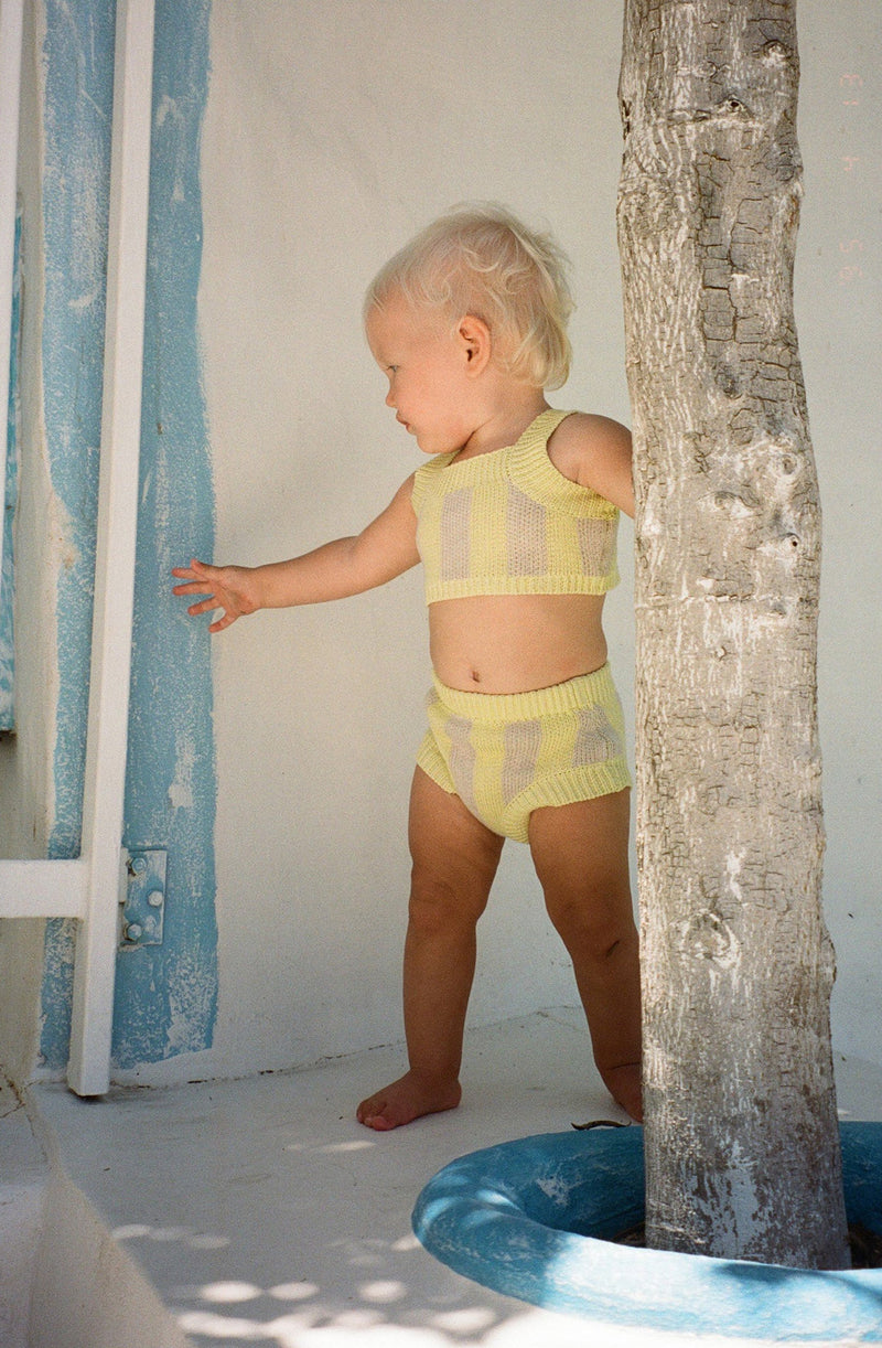 Baby standing up wearing the limon knit set