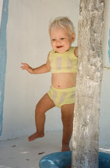 Baby taking a step wearing the limon knit set