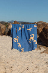 Dino swaddle hanging on clothes line at the beach