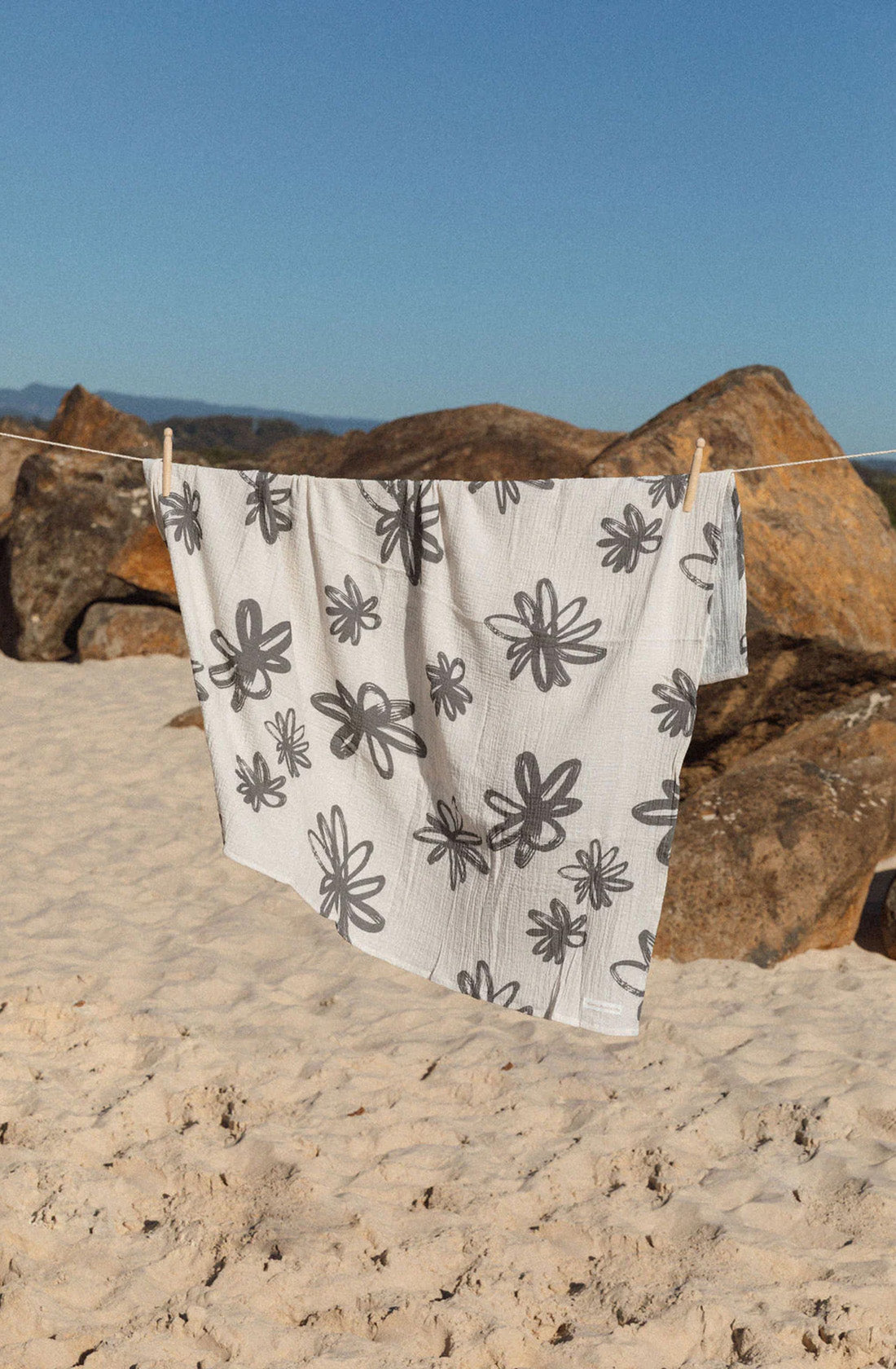 Flora swaddle hanging on clothes line at the beach