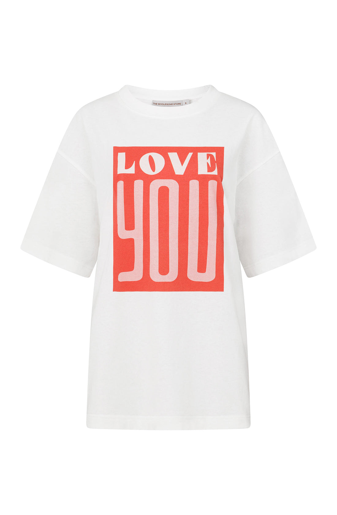 The Love You Tee by THE WHOLESOME STORE is a white, short-sleeved T-shirt with an oversized fit and longer sleeves. It features a bold red rectangular graphic on the front, emblazoned with the words "LOVE YOU" in large white font. Made from 100% cotton, this minimalist design emphasizes the impactful message.