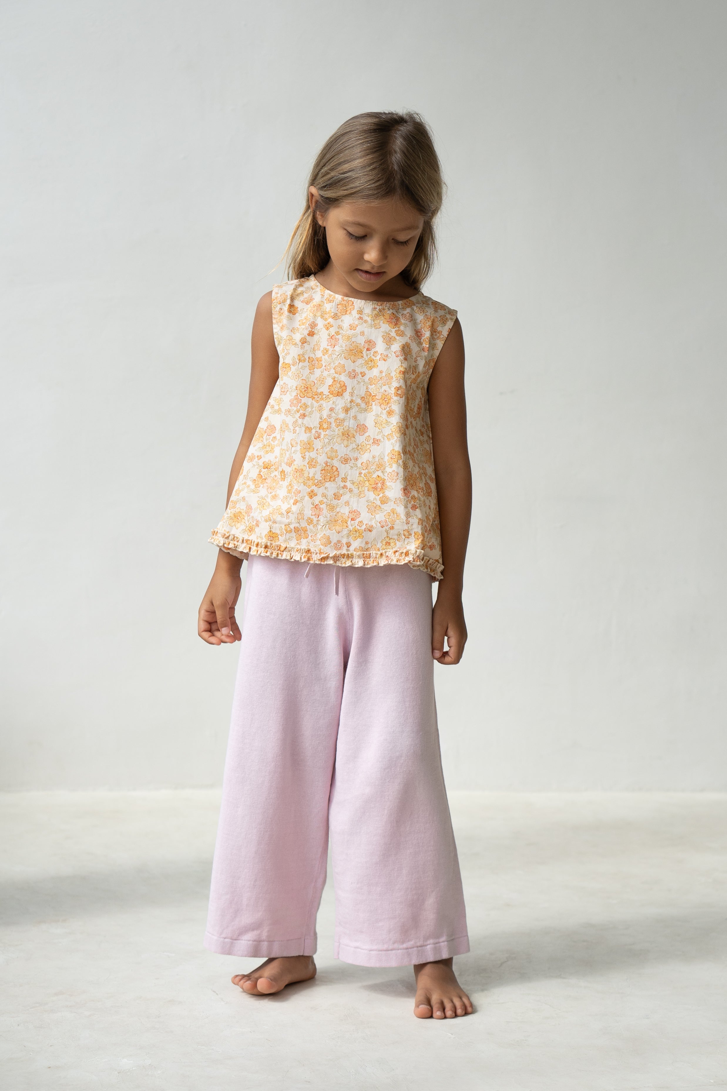 Young girl wearing the tilly blouse in buttercup.