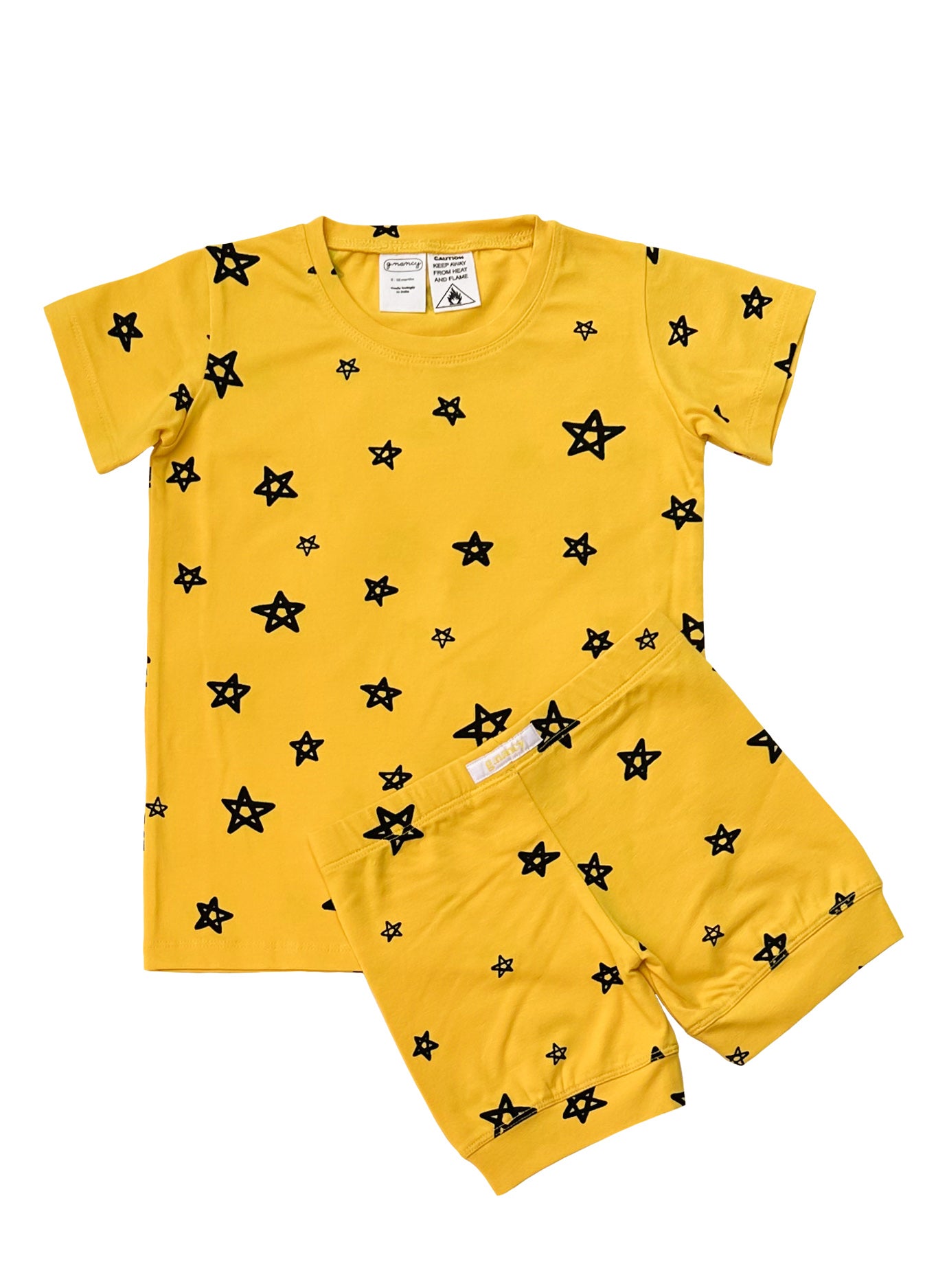 Introducing the Star Shortie PJ Set Lemon by G.NANCY, a yellow children's ensemble featuring a short-sleeved shirt and matching shorts adorned with black star patterns. Made from organic cotton sleepwear, this GOTS-certified set promises a snug yet comfortable fit for playful days or dreamy nights.