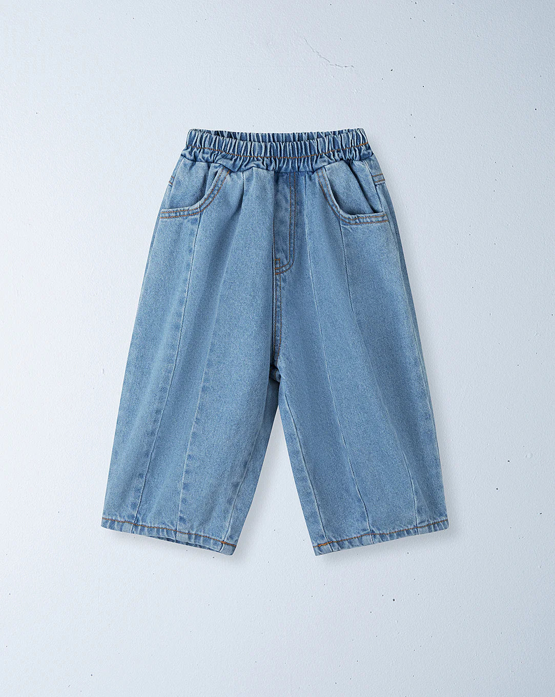ZIGGY ZAZA's Suki Denim Jean Light Wash Denim shorts feature an elastic waistband, two side pockets, and visible front seam details, shown laid flat on a light grey background.