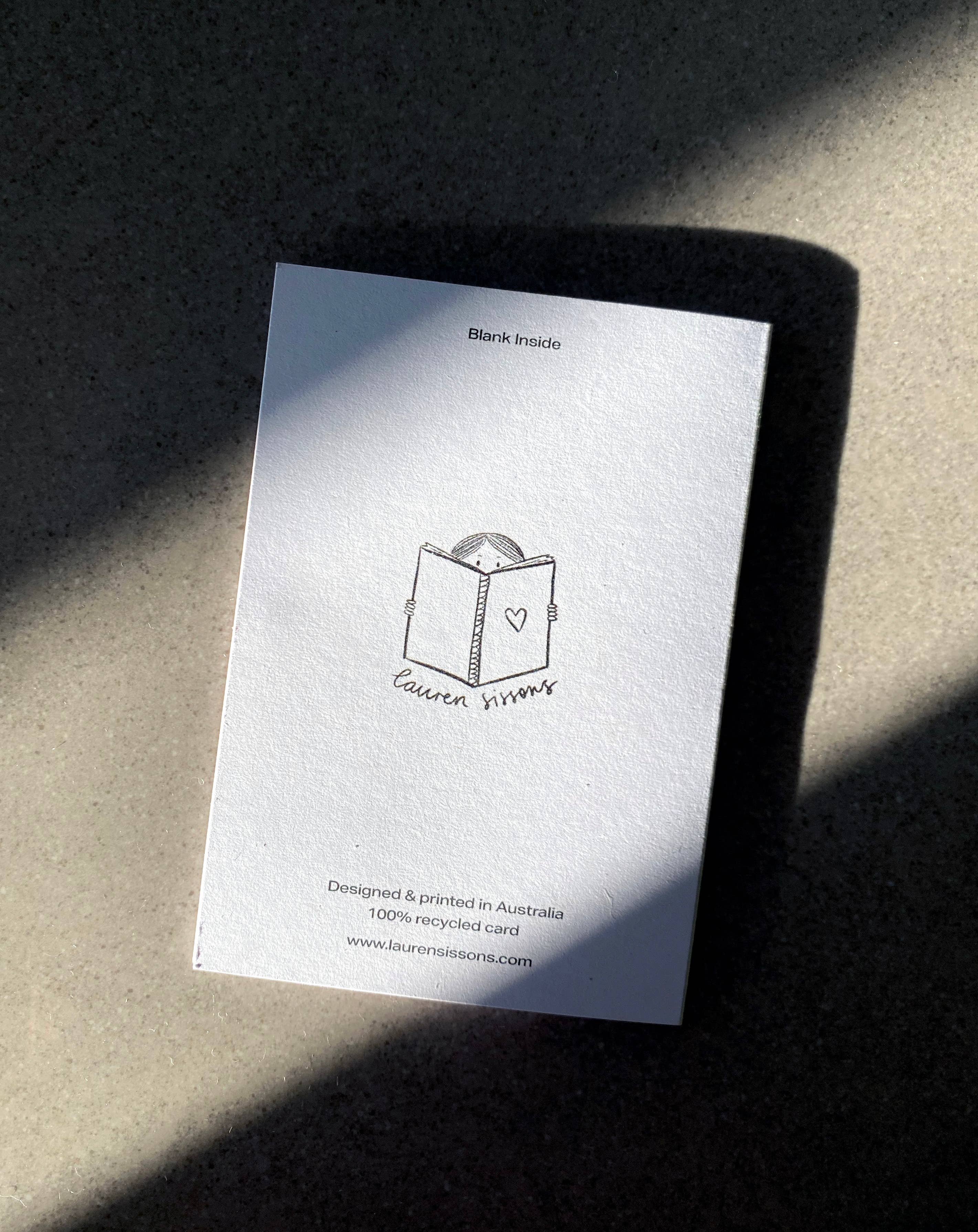 A white mini card titled "Blank Inside" at the top features a minimalist illustration of a closed envelope with a heart and is branded by "LAUREN SISSONS STUDIO." The text at the bottom states "Designed & printed in Australia, 100% recycled paper.