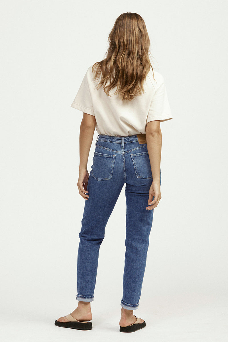 Rear view of woman in white t-shirt and blue jeans