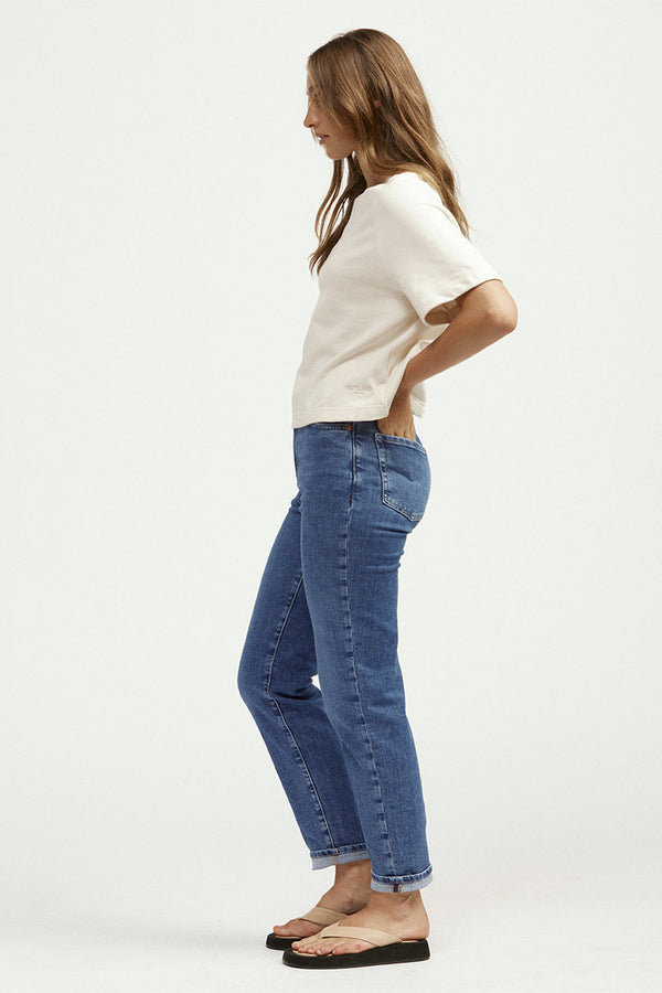 Side view of woman in white t-shirt and blue jeans
