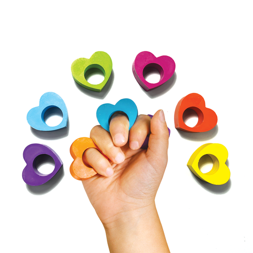 A hand with two heart ring crayons on the pinky and middle finger with six others around the hand on a white background.