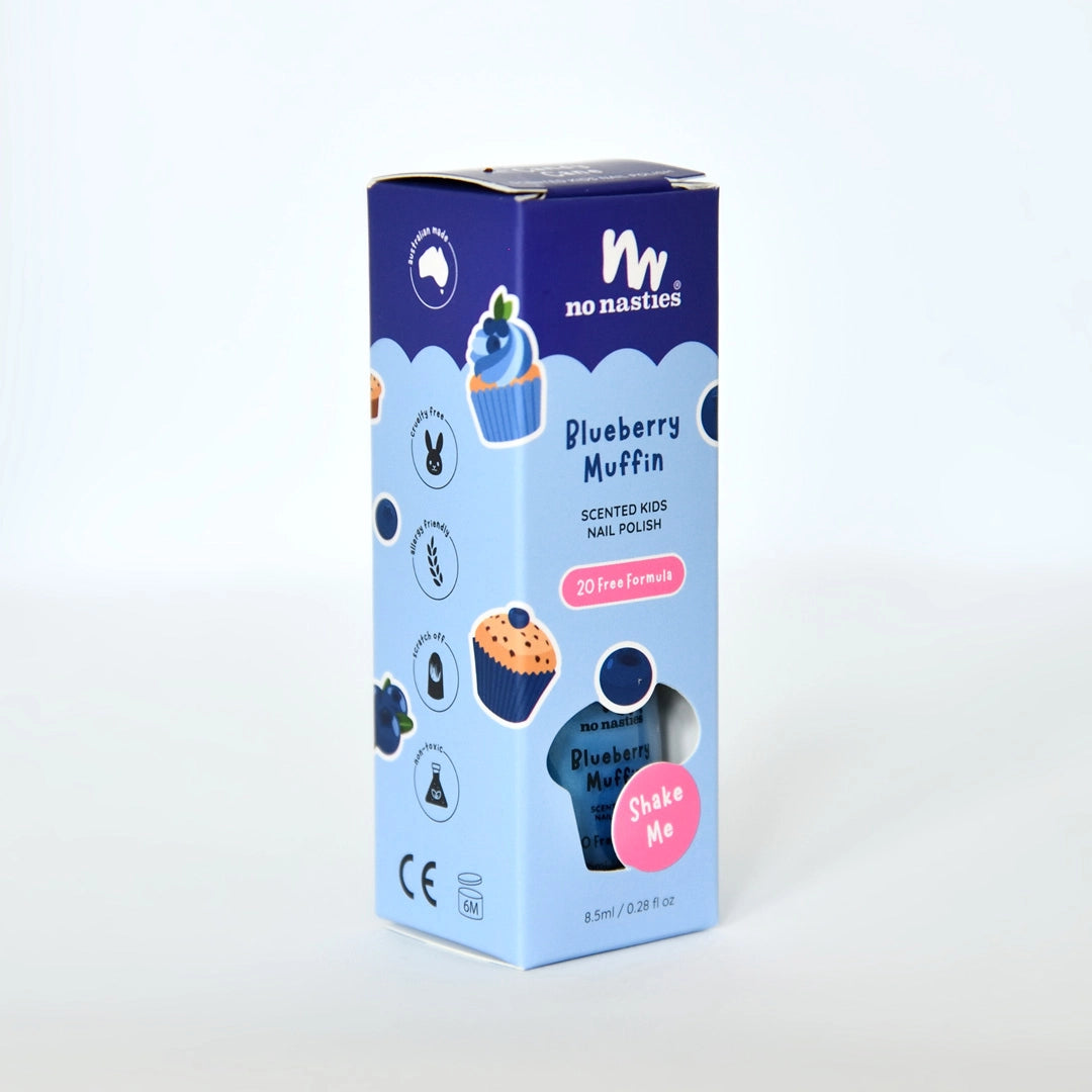 The NO NASTIES "No Nasties - Scented Scratch Off Kids Nail Polish Blueberry Muffin/Blue" comes in a blue and purple rectangular box with muffin and blueberry graphics, a pink "Shake Me" sticker, and features a vegan blueberry muffin scent.