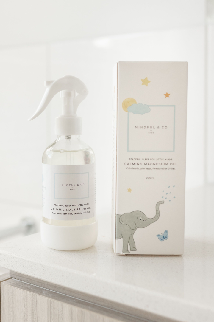 Mindful & Co calming magnesium oil spray bottle and packaging on a bathroom vanity.