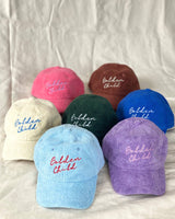 7 Terry towering kids caps in baby blue, creme, pink, brown, green, purple and Blue.