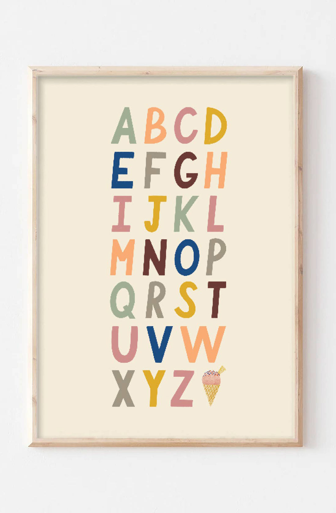 The Bold A-Z Alphabet Wall Art Print from LAUREN SISSONS STUDIO showcases the alphabet with each letter uniquely colored in a variety of bold hues. Arranged in five rows, this piece is perfect nursery decor with an educational artwork twist, and features an illustration of an ice cream cone beside the letter "Z" at the bottom right corner.