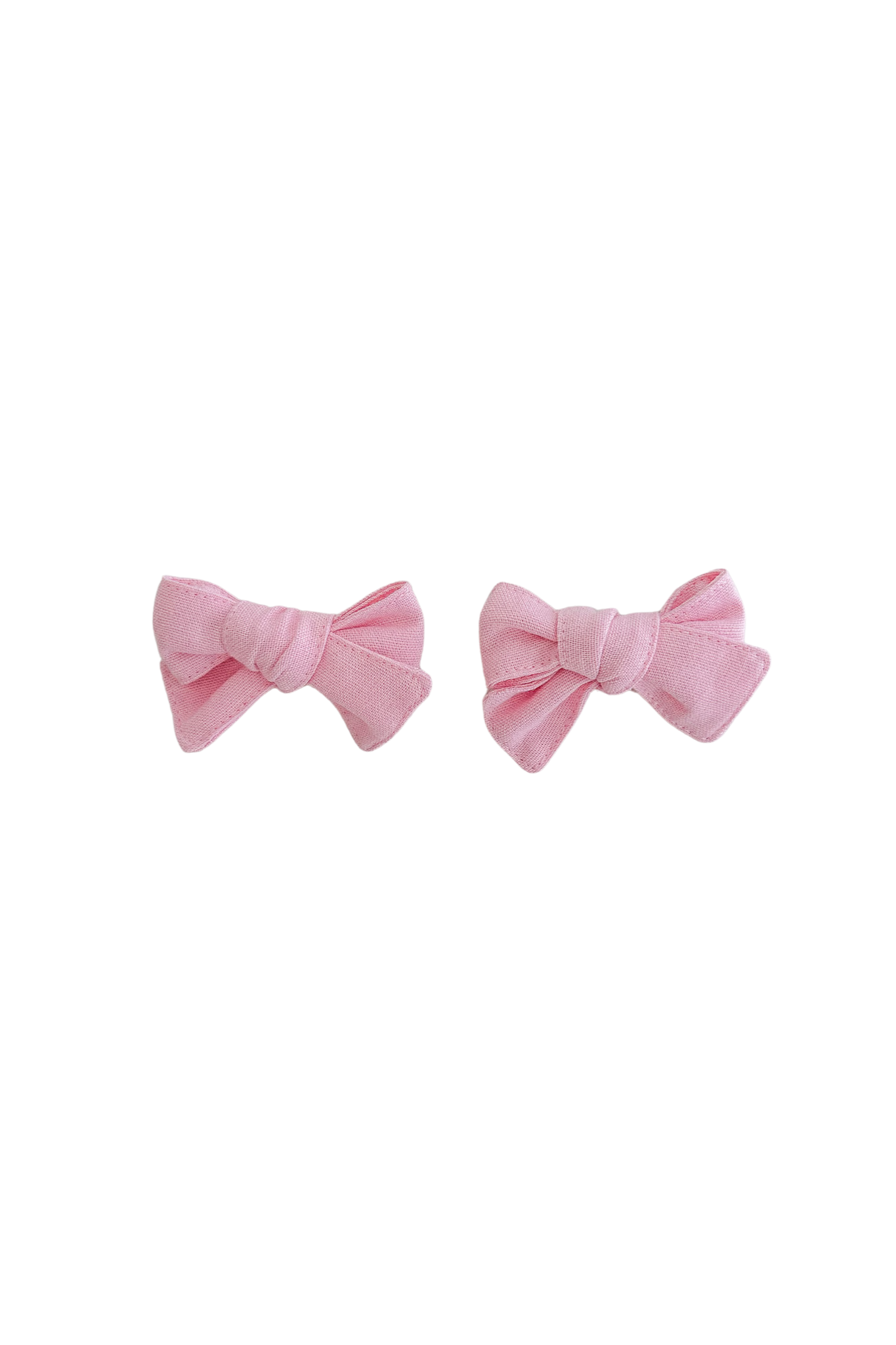 Two ZIGGY LOU Bows Freya hair bows, made from 100% cotton in a charming pink hue, are placed against a black background. The intricately crafted bow clips are symmetrically arranged side by side, each featuring a sleek texture and an understated, elegant design.