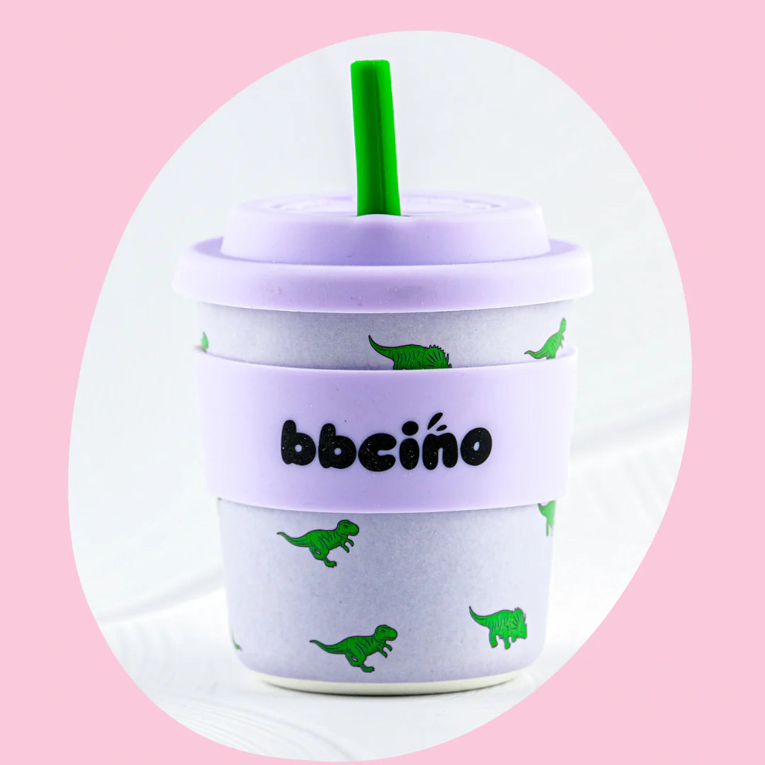 Enjoy your favorite drinks with the BBCINO Reusable BambinoCino Cup 240ml Dino-mite, featuring a secure lid and a reusable silicone straw.