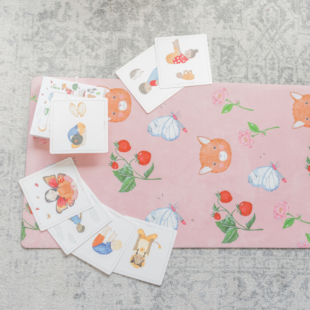 The sweet theme Pink yoga mat with cards scattered over it.