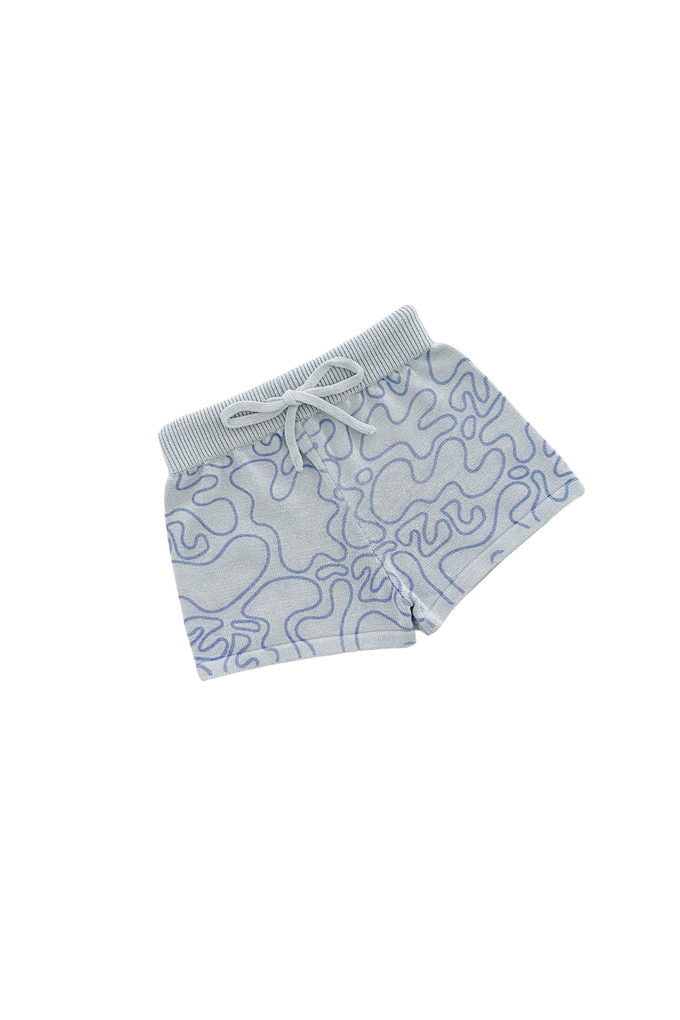 Introducing the Shorts Zen by ZIGGY LOU, a part of our Summer Collection. These light blue knitted shorts are adorned with a wavy blue pattern on a Zen design, complemented by an elastic waistband and set against a plain black background.