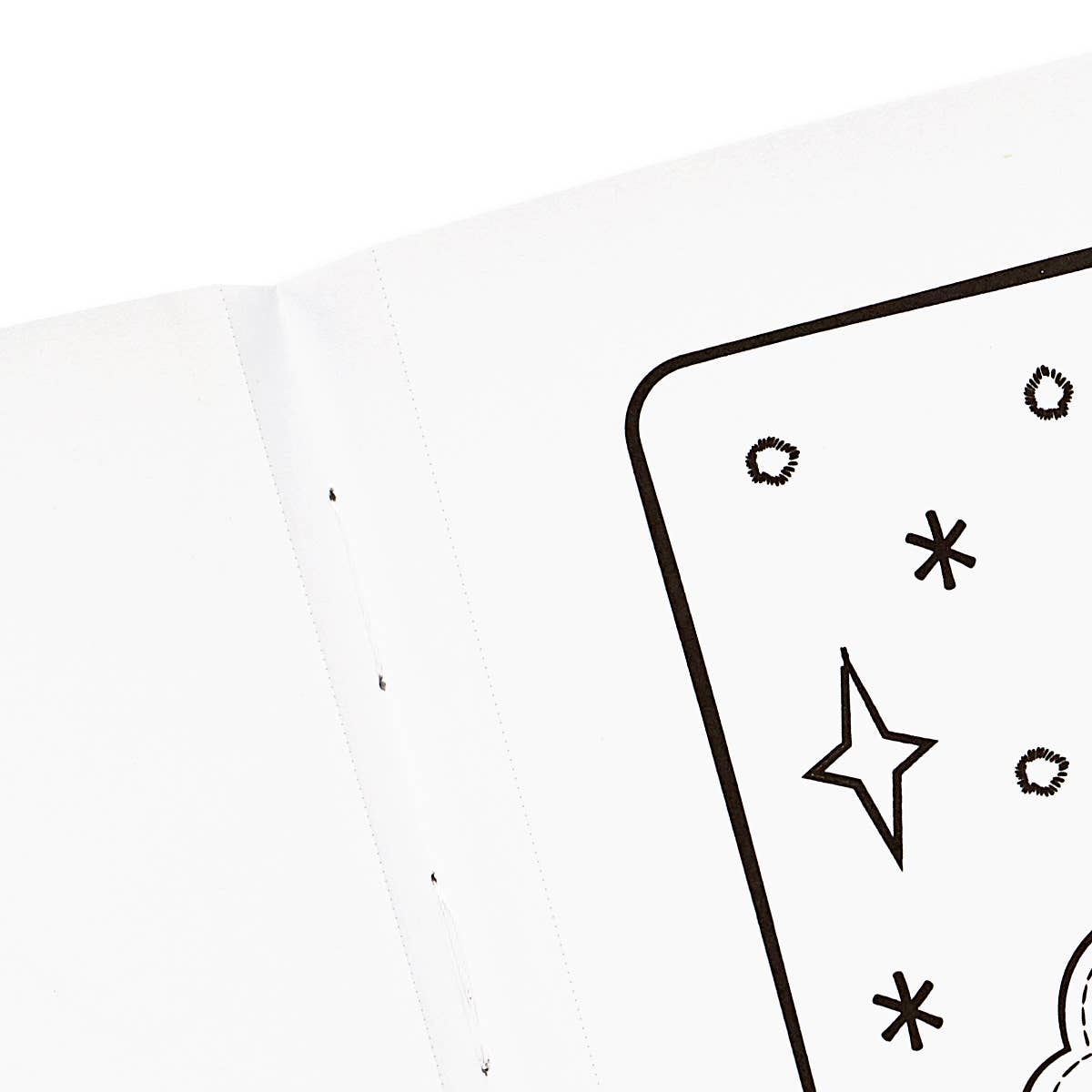 The corner of a page in a colour in book with stars and dot on it.