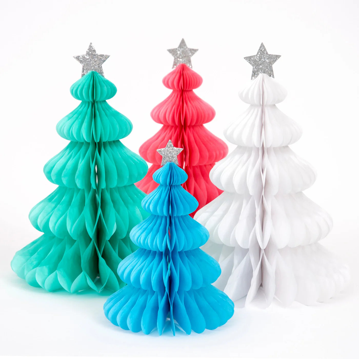 Create a festive and colorful display with the Rainbow Forest Honeycomb Decorations by MERI MERI. This set includes four honeycomb trees in teal, blue, pink, and white, each featuring a star topper and a folded layered design made from tissue paper.