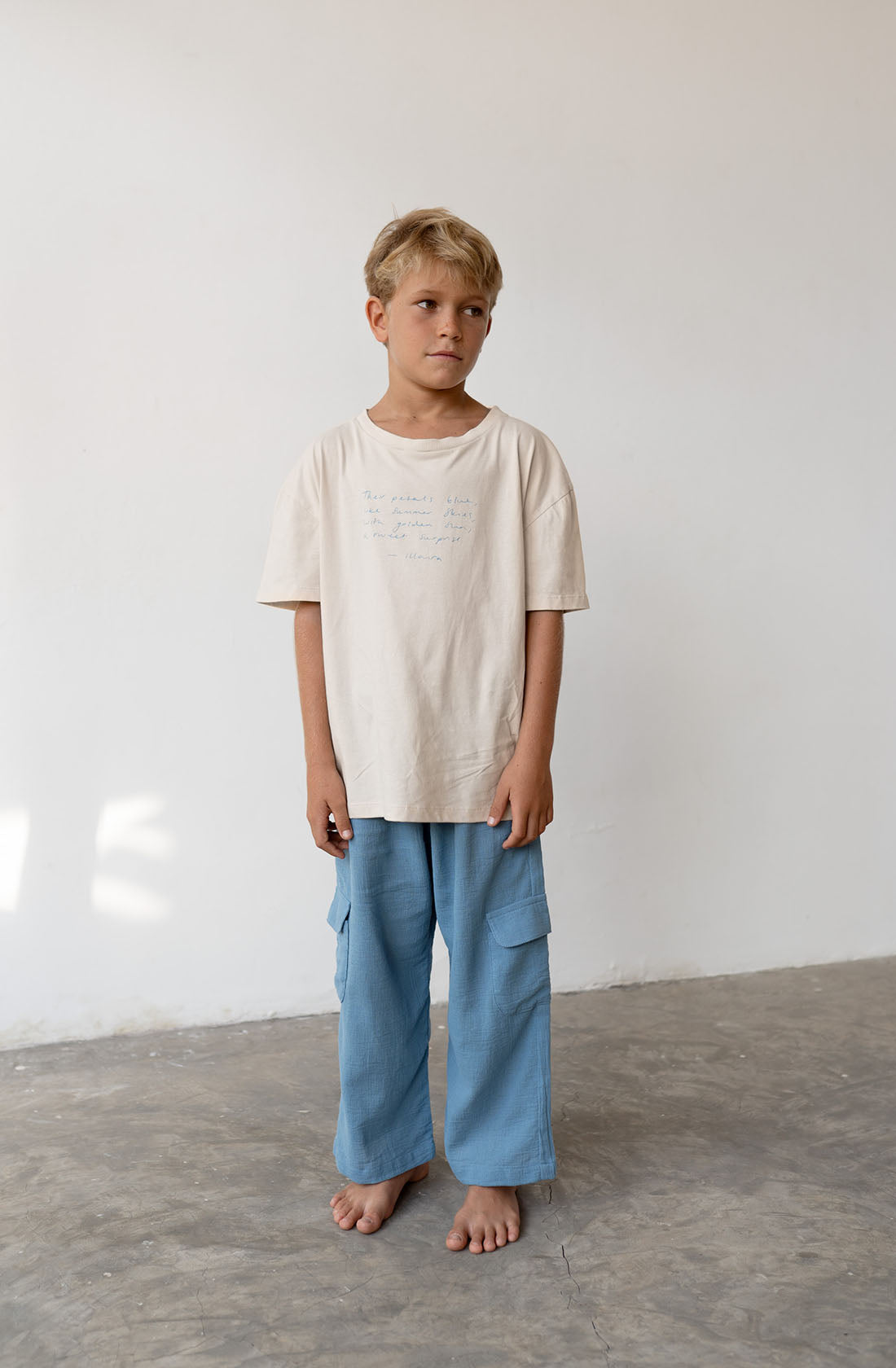 Young boy wearing the poet tee undyed with the hennie cornflower pants.