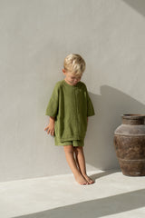 Blonde toddler boy wearing olive knit tee and shorts