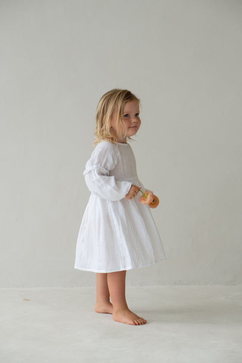 Side of girl wearing the white Maggie dress, showing sleeve detail