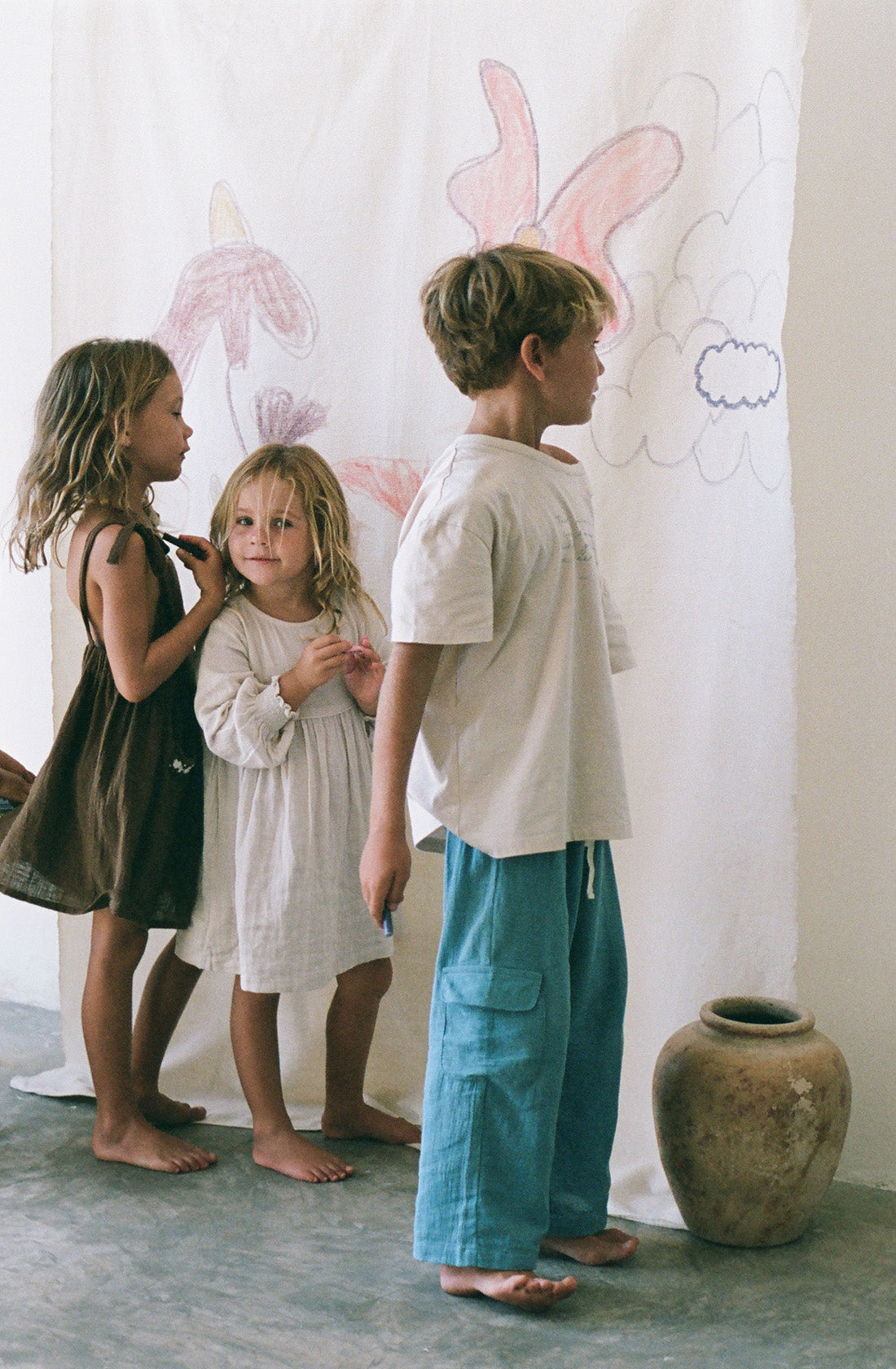 Young boy wearing the poet tee undyed and the henna cornflower pants.