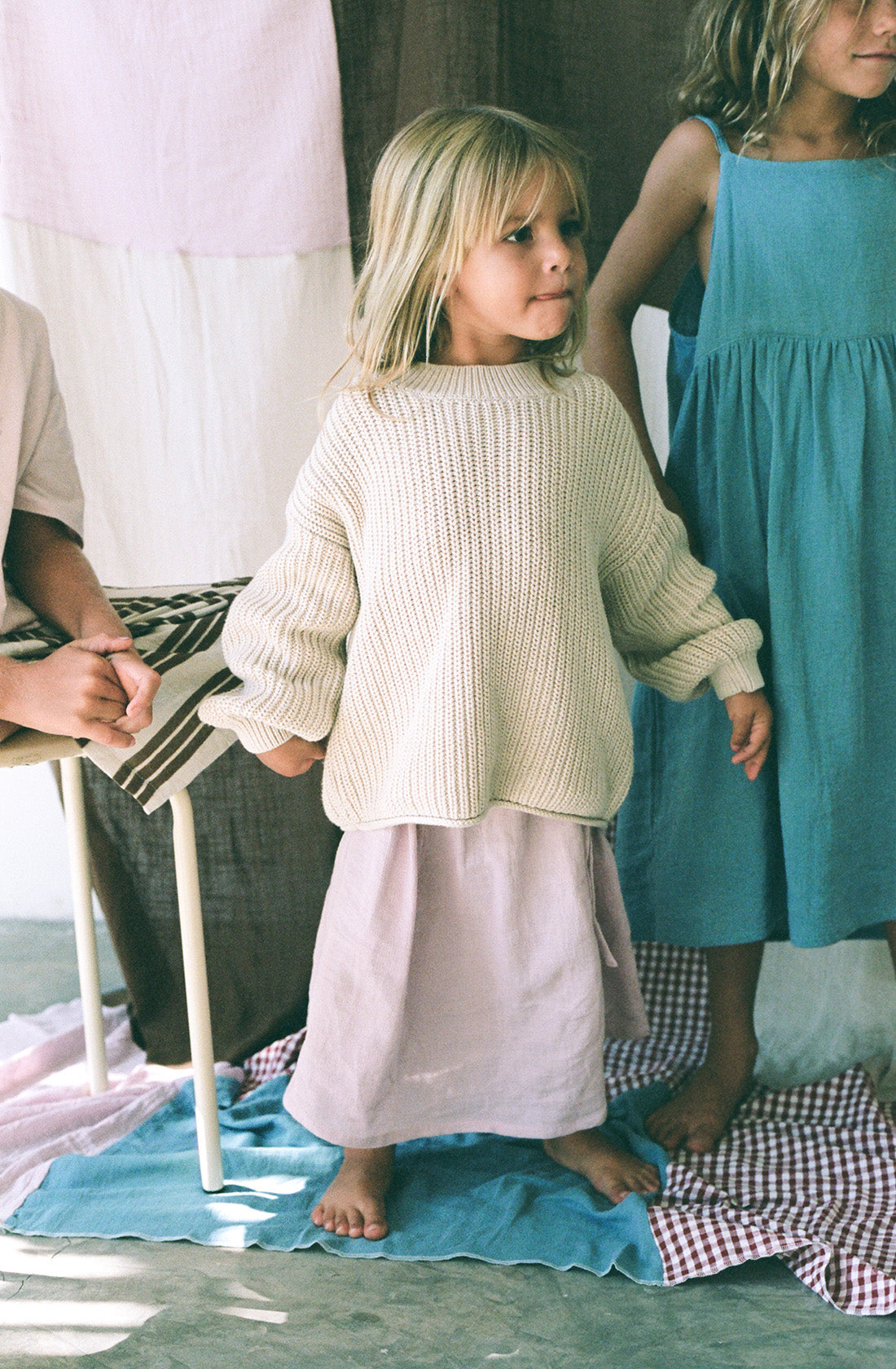 Young girl wearing the chunky knit jumper in natural.