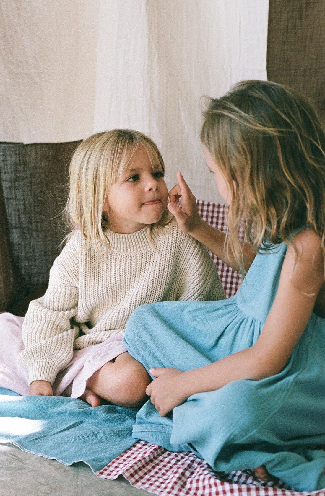 A young girl wearing the chunky knit jumper natural.