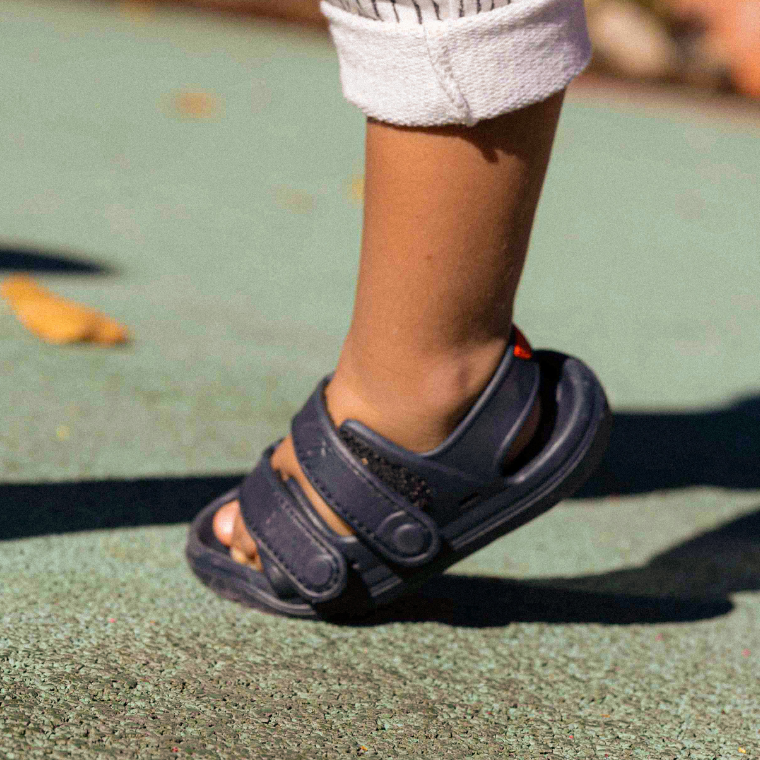 Close-up of a child's foot in a Simples WonderSkips sandal in Bondi Blue